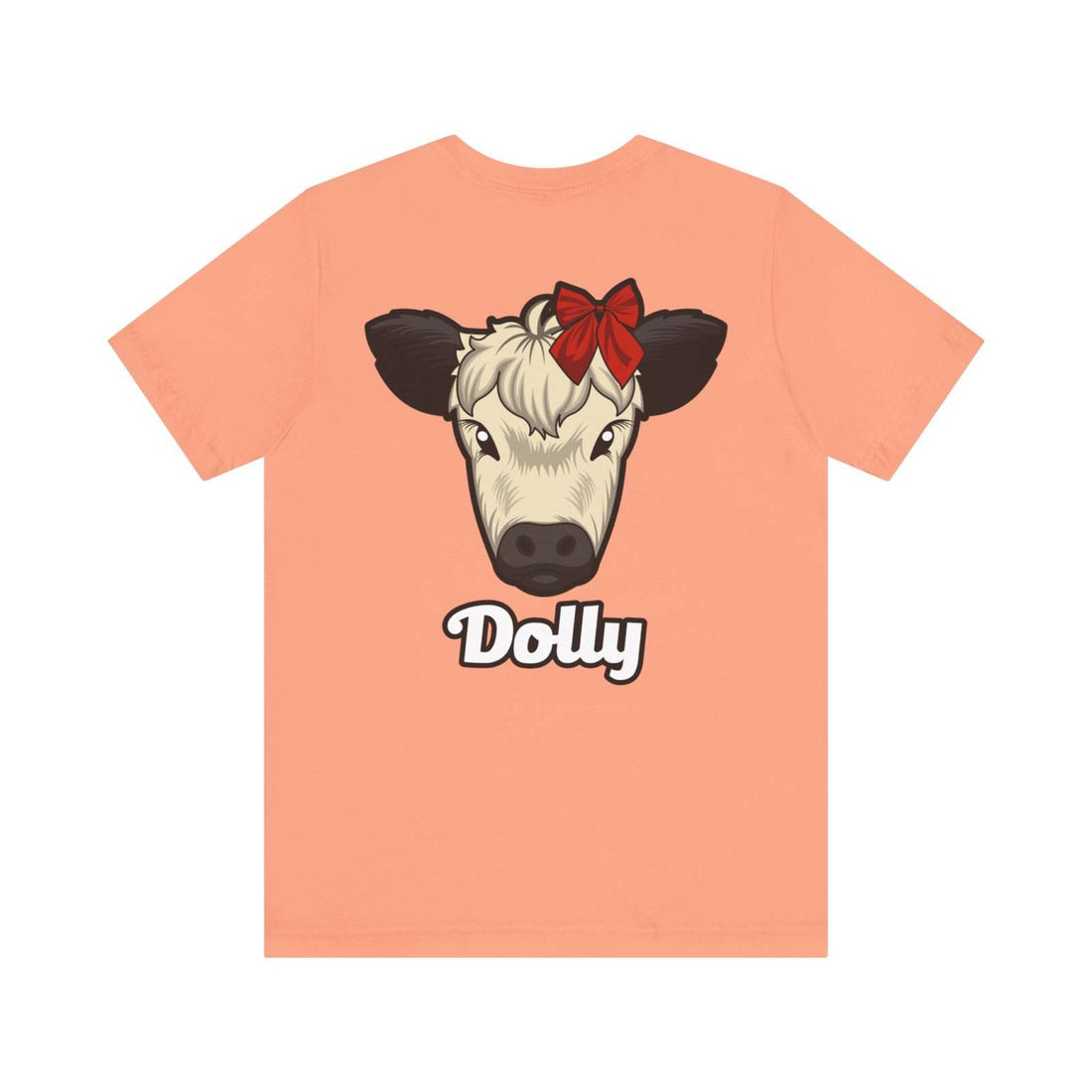 Peach Country Cow Graphic Tee featuring Dolly cow with red bow and text below.