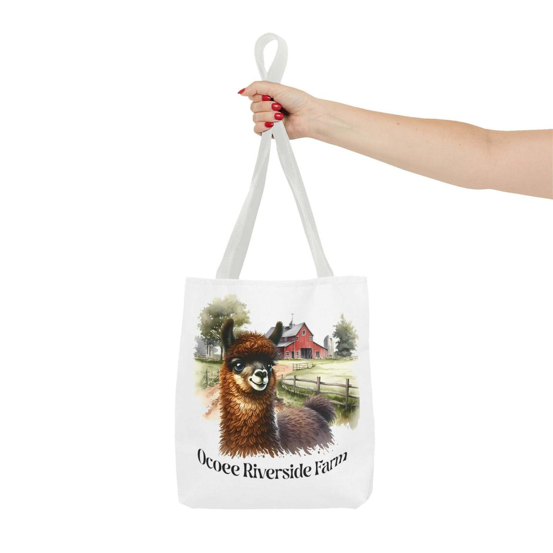 White tote bag featuring a cute llama illustration and Ocoee Riverside Farm text, held by hand