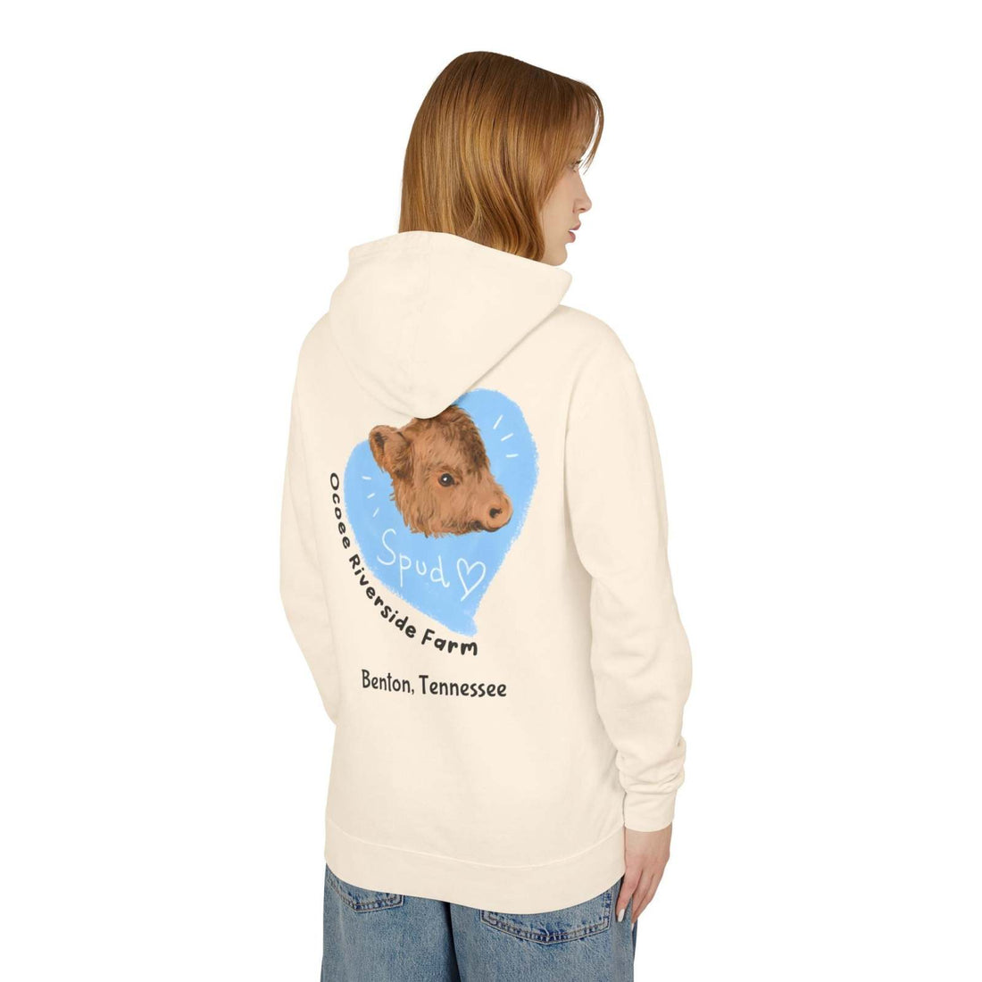 Woman wearing a cozy Cute Cow Lightweight Hoodie with a calf graphic and farm name on the back, in a soft cream color