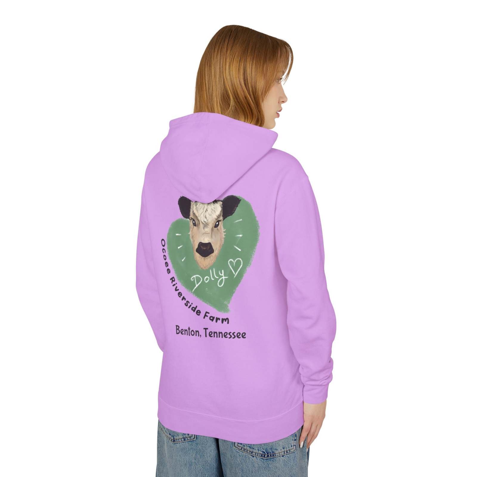 Woman wearing a lavender Cozy Cow Hoodie with a cow illustration and "Ocoee Riverside Farm, Benton, Tennessee" text on the back