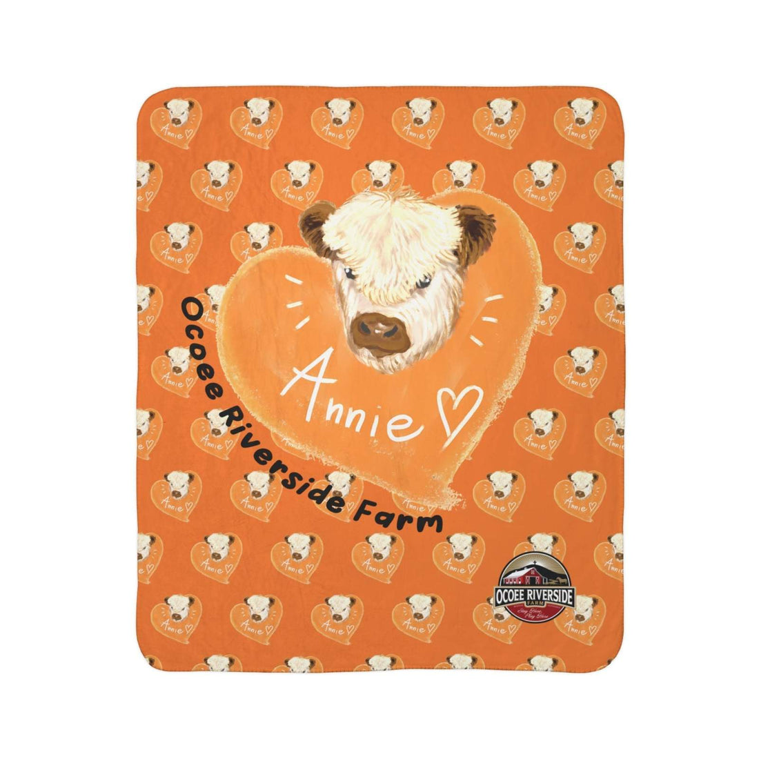Orange cow-themed Sherpa blanket with heart pattern and cow illustration, featuring "Annie" and Ocoee Riverside Farm logo