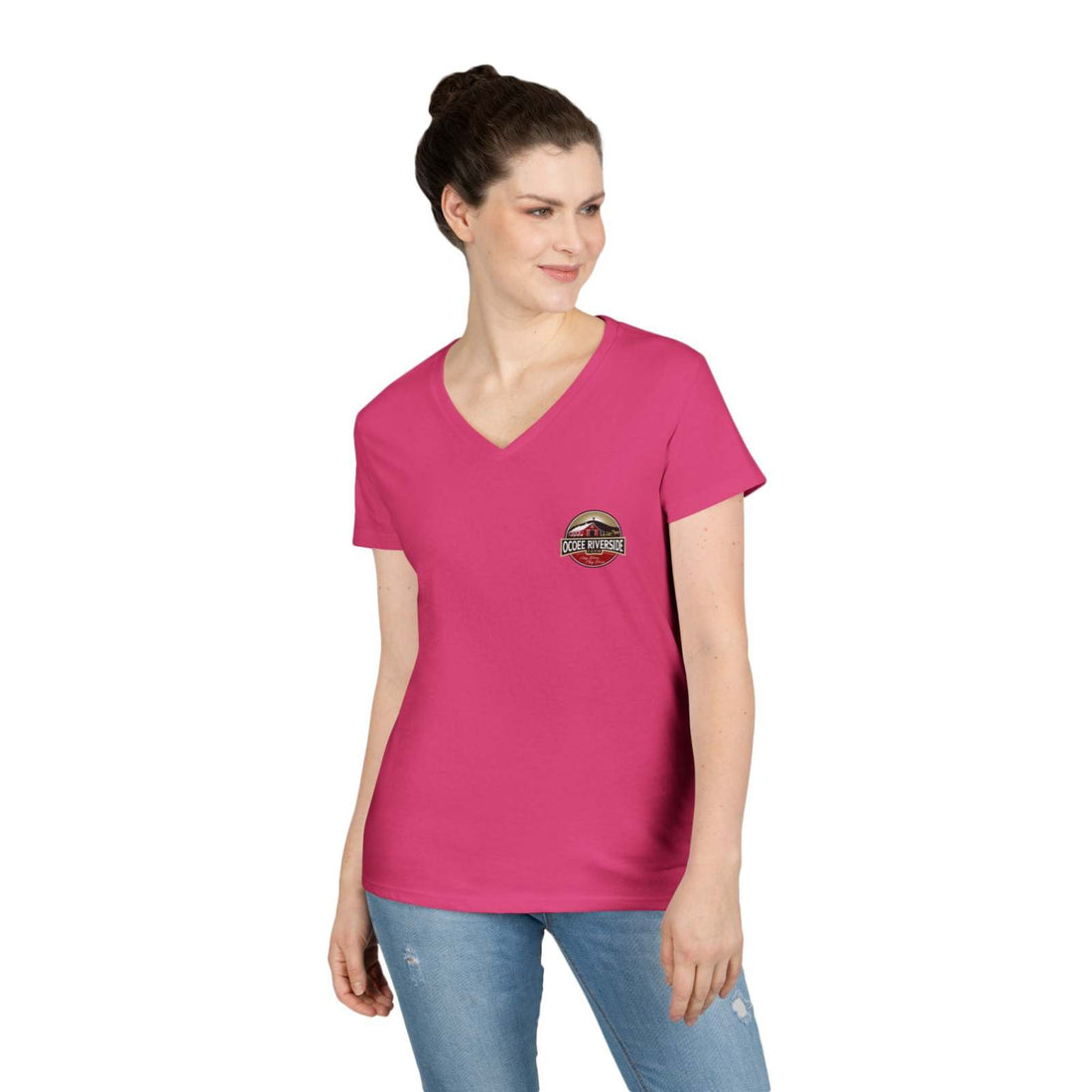 Woman wearing pink Spud Heart Women’s V-Neck T-Shirt with Ocoee Riverside Farm logo, paired with jeans.