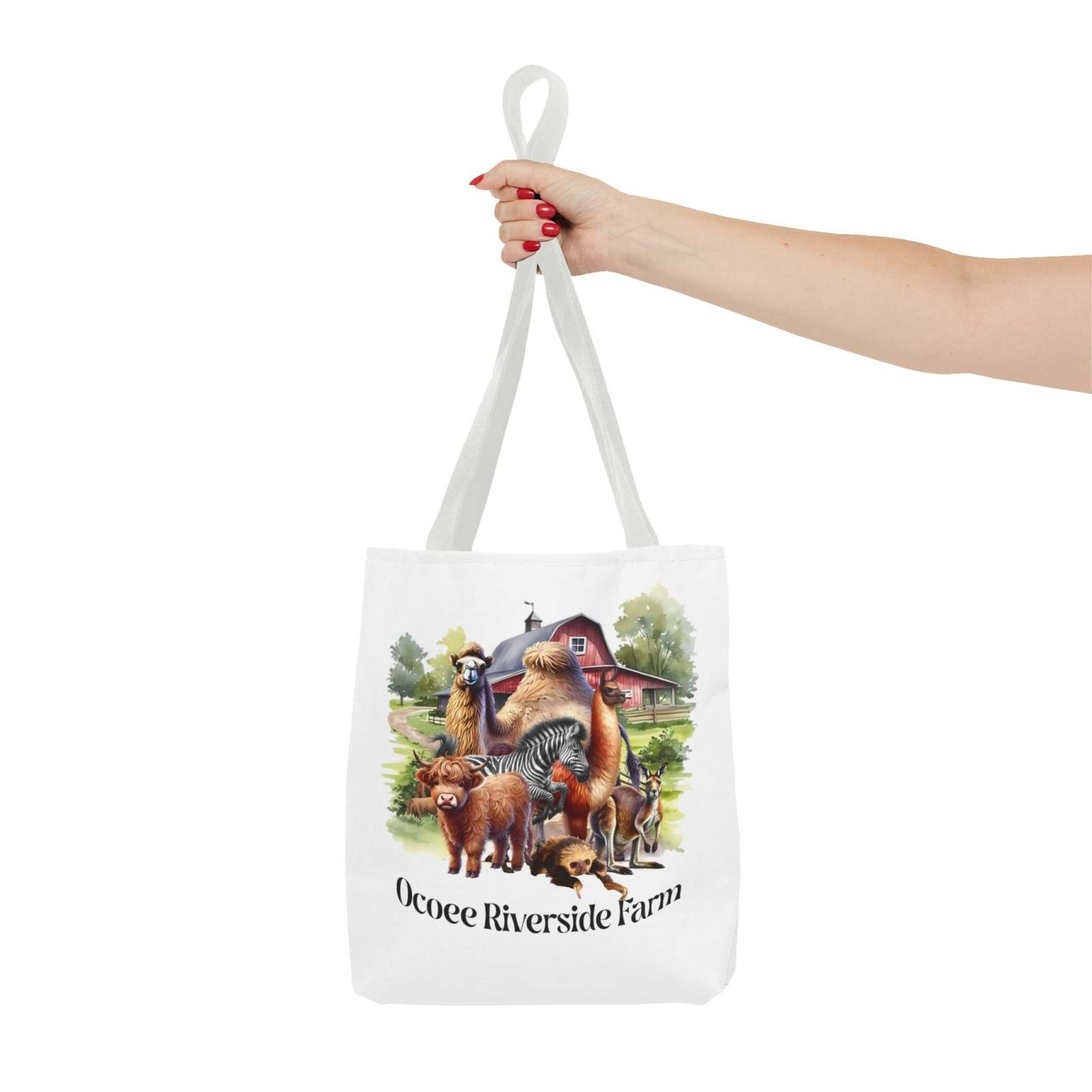 White eco-friendly animals tote bag with Ocoee Riverside Farm design featuring various farm animals, held by a hand against white background