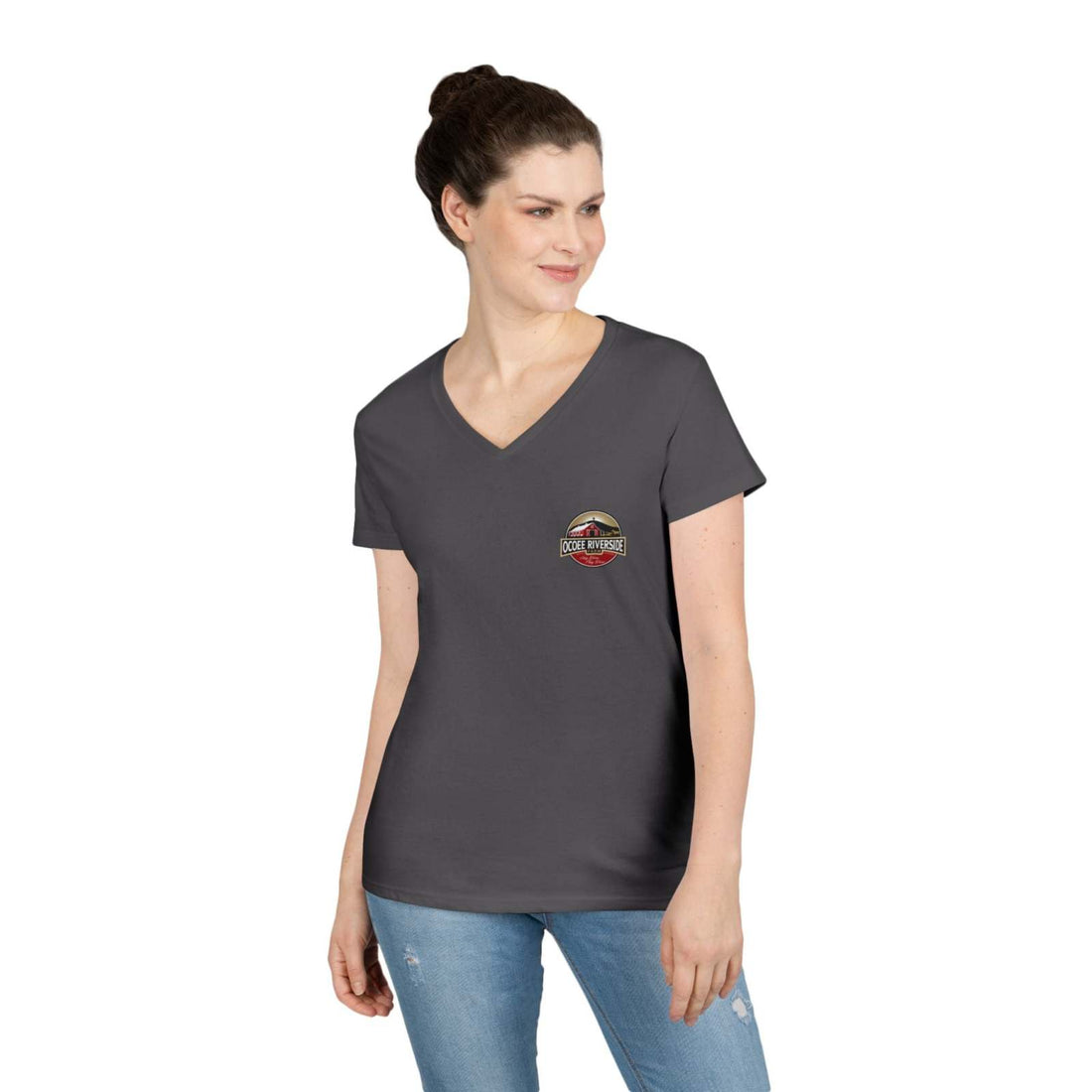 Woman wearing a Rustic Farm Style V-Neck charcoal gray t-shirt with small farm-themed logo on chest, paired with blue jeans.