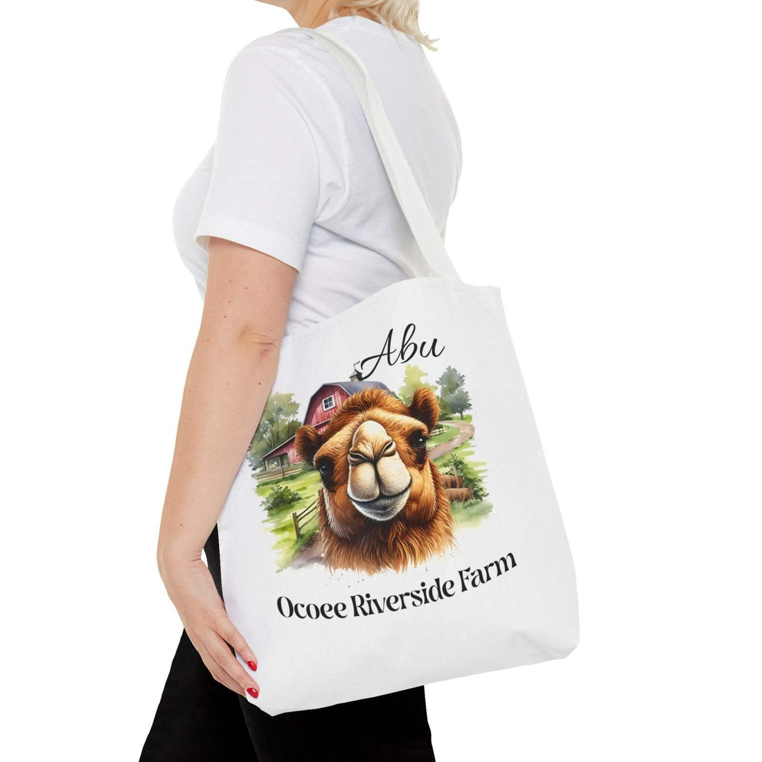 Woman carrying Abu Camel Tote Bag with camel illustration and Ocoee Riverside Farm text, eco-friendly shopping bag design