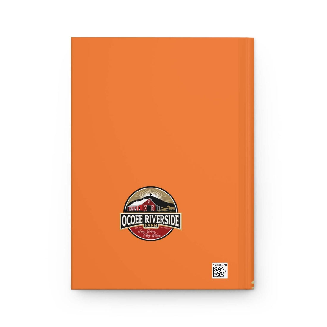 Orange hardcover farm journal with Ocoee Riverside Farm logo featuring a red barn and cow-themed design
