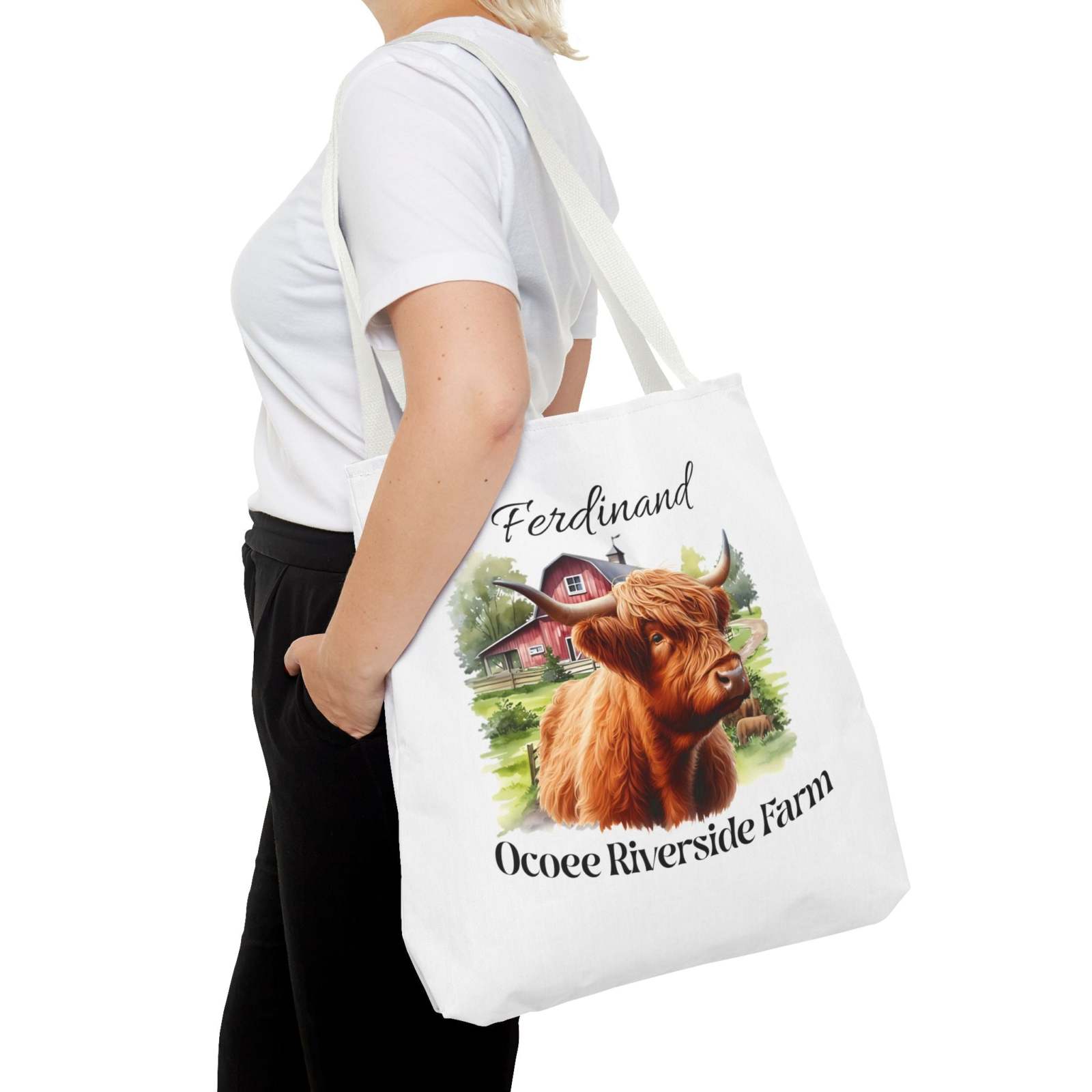 Woman carrying white eco-friendly shopping tote bag with Highland cow and Ocoee Riverside Farm design