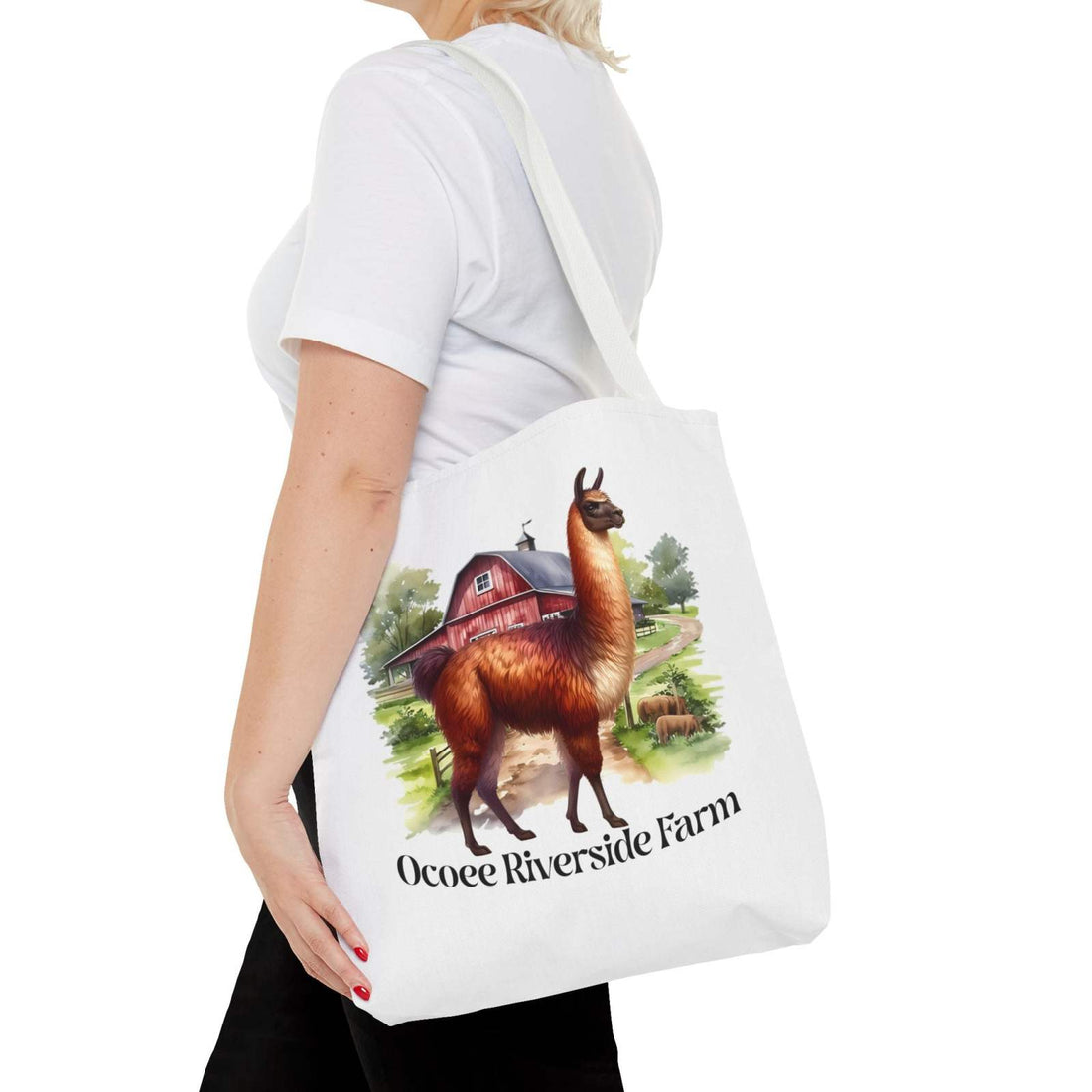 Woman carrying a white Alpaca Tote Bag from Ocoee Riverside Farm with alpaca and barn illustration, eco-friendly shopping bag design