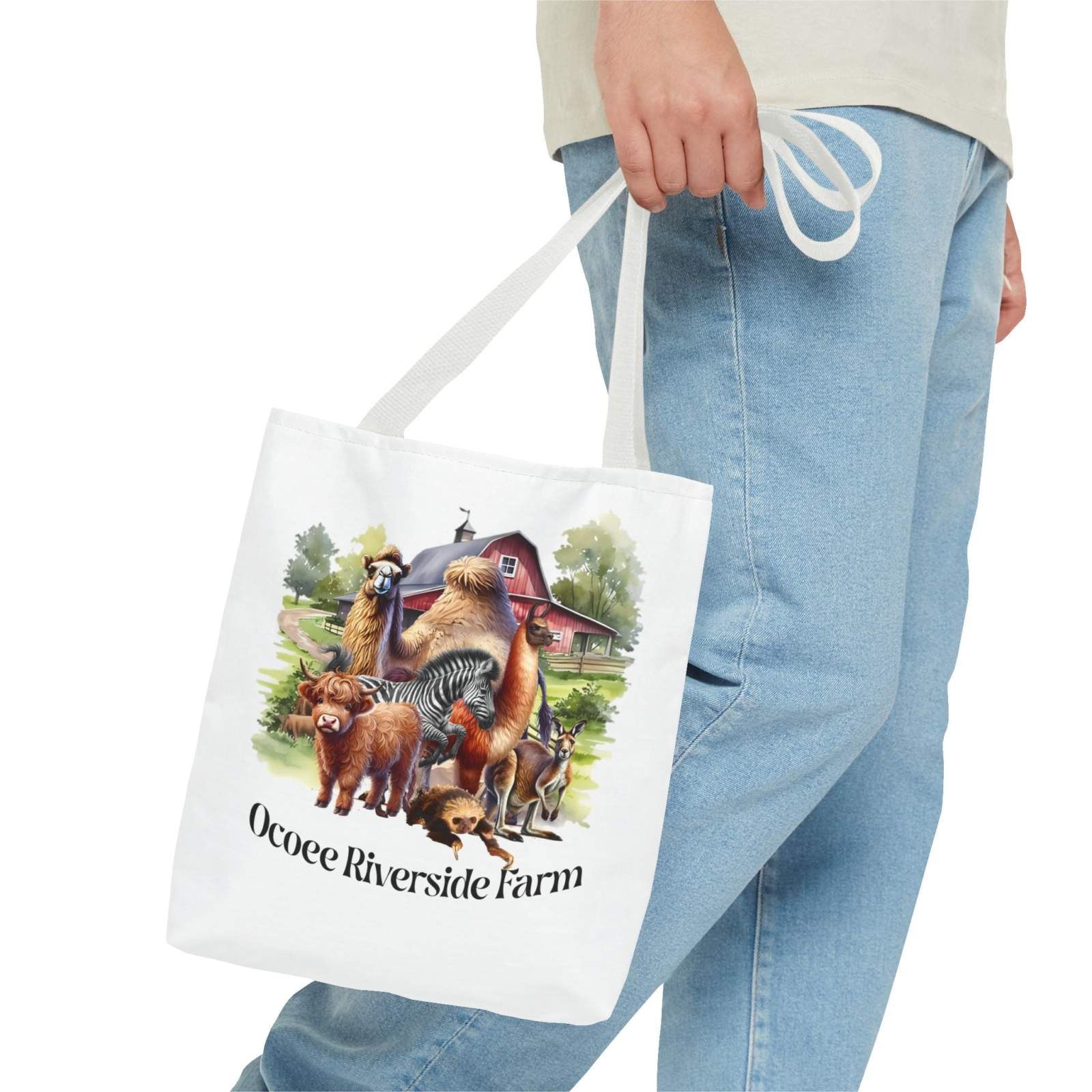 Eco-friendly Animals Tote Bag featuring farm animals and Ocoee Riverside Farm design, held by person wearing jeans.