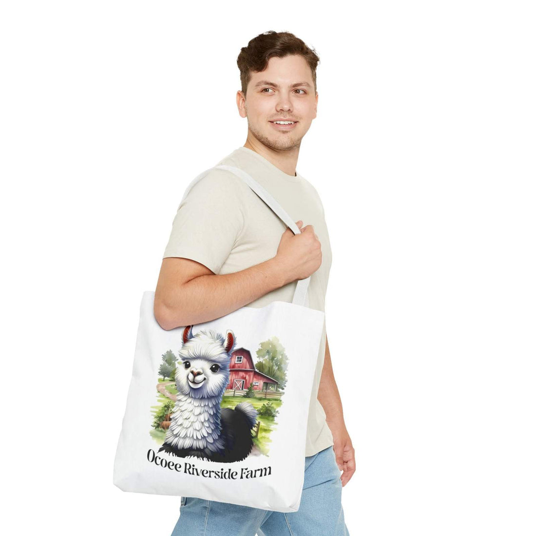 Man carrying white eco-friendly Alpaca Tote Bag featuring Ocoee Riverside Farm design with alpaca and barn illustration