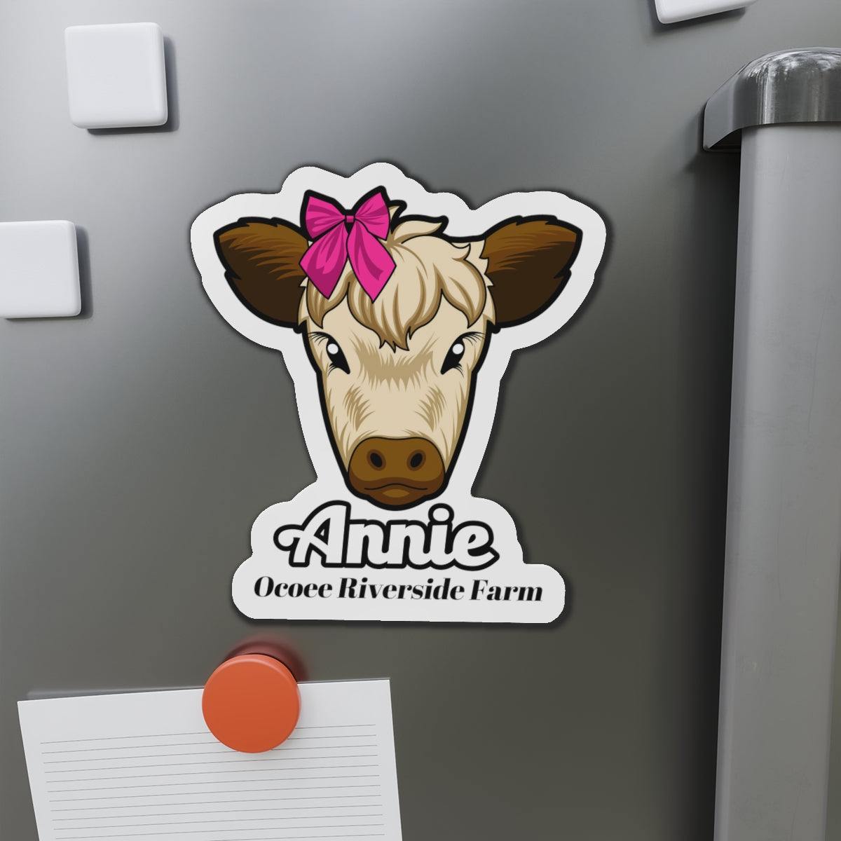 Cow die-cut magnet featuring a cute cow face with a pink bow and personalized text, ideal for fridge or office decor.