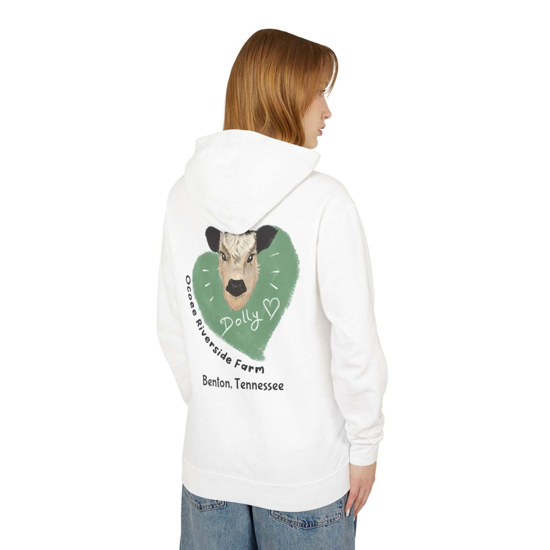 White Cozy Cow Hoodie with cow graphic and "Ocoee Riverside Farm" text on back, worn by a woman