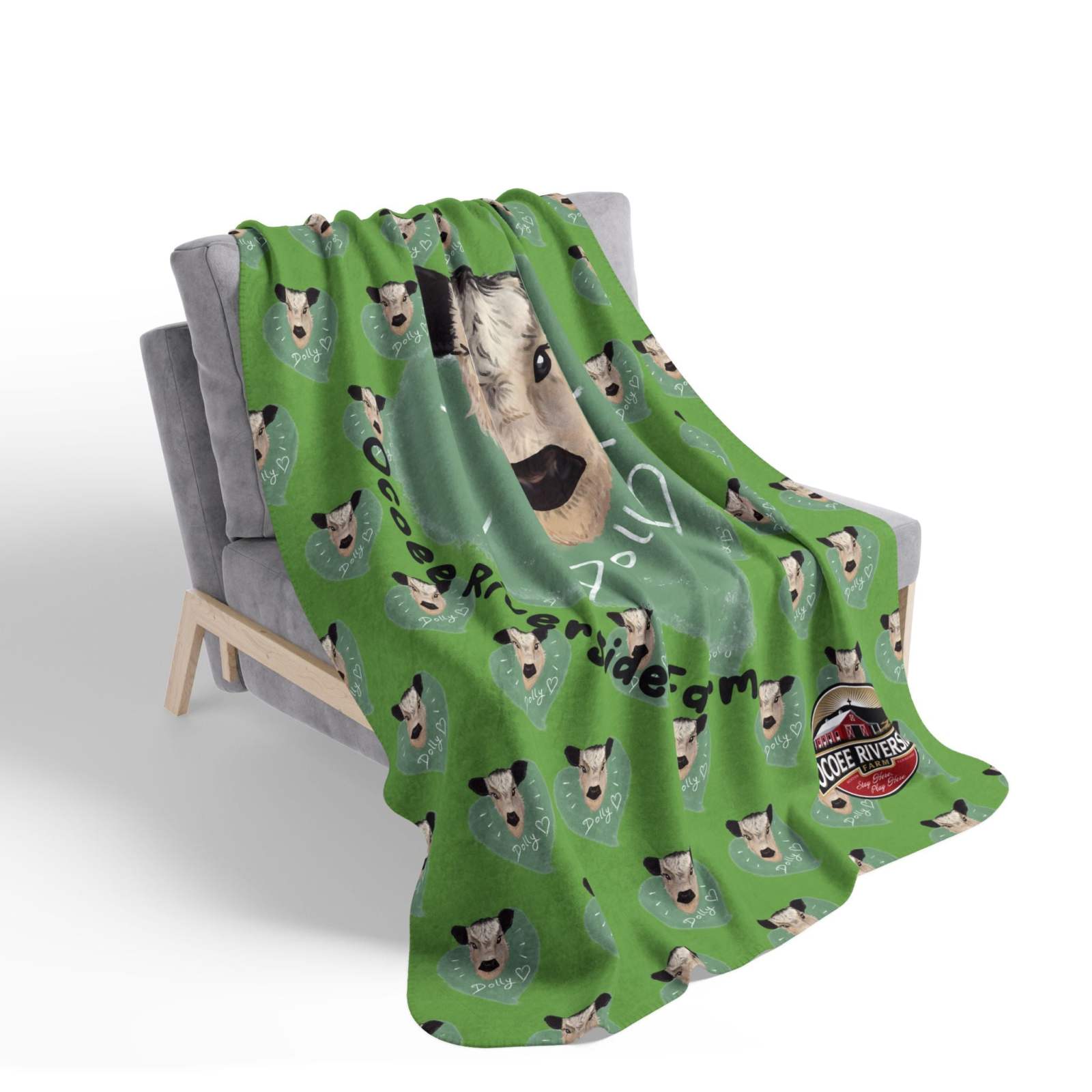 Cozy Spud the Cow Blanket soft green sherpa throw with cow faces draped on gray chair