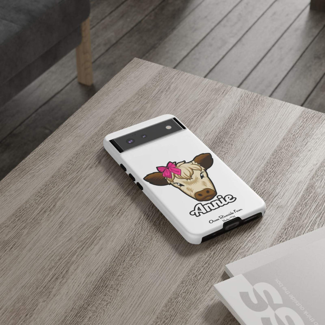 cute cow phone case with red bow on table, ideal farm animal lover gift