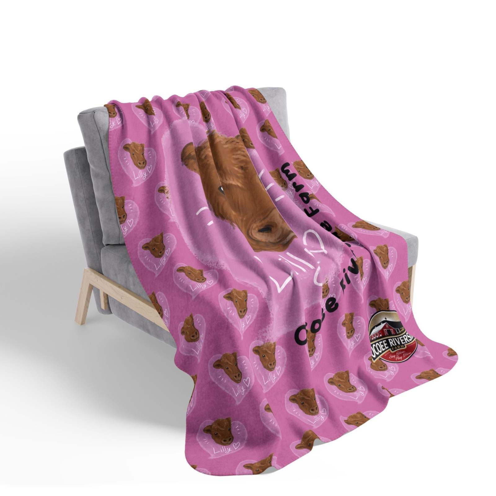 Pink Farm Animal Sherpa Blanket featuring a cow design draped over a gray chair