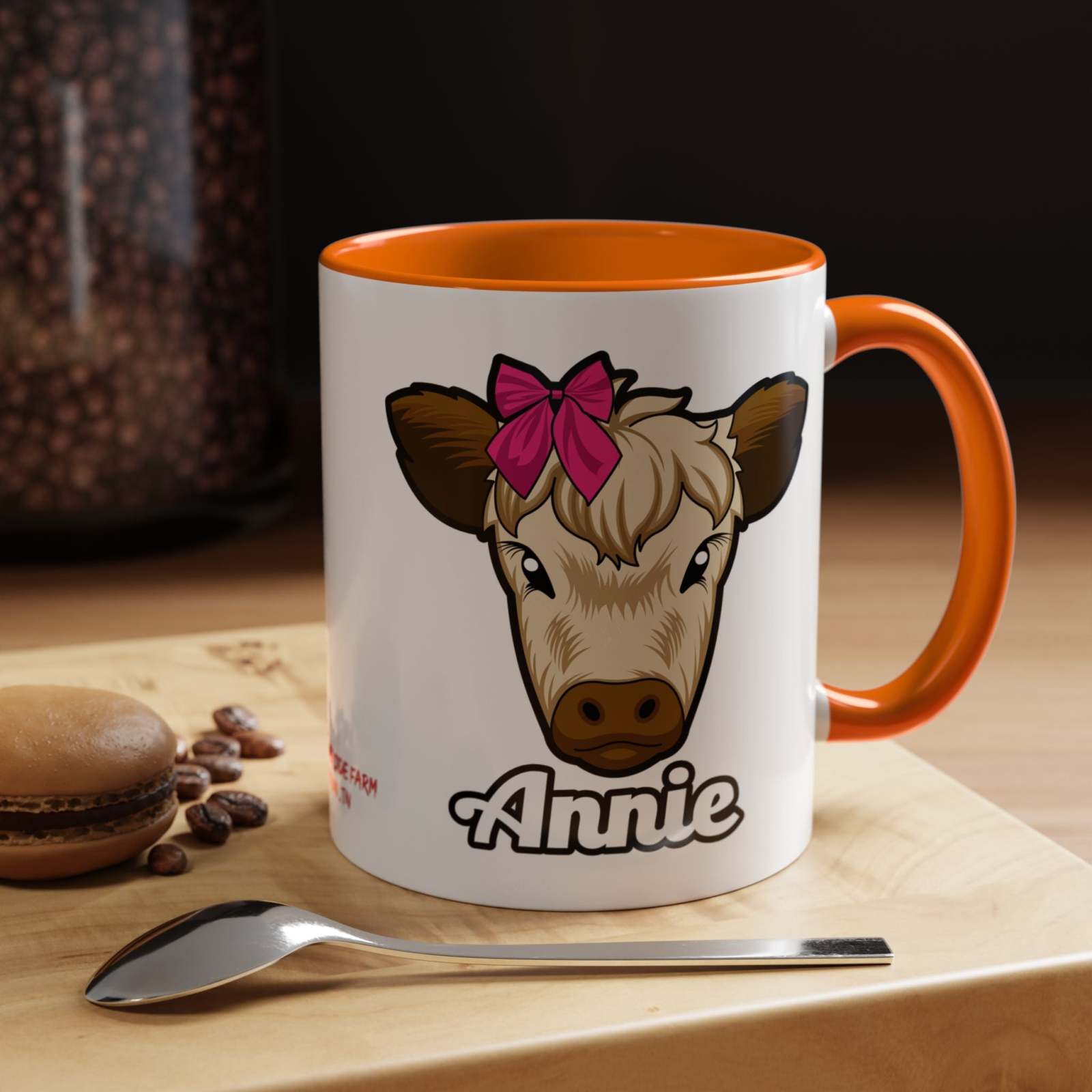 Farmhouse cow coffee mug with red bow design, featuring "Annie" text, perfect for rustic kitchen décor and animal lovers.