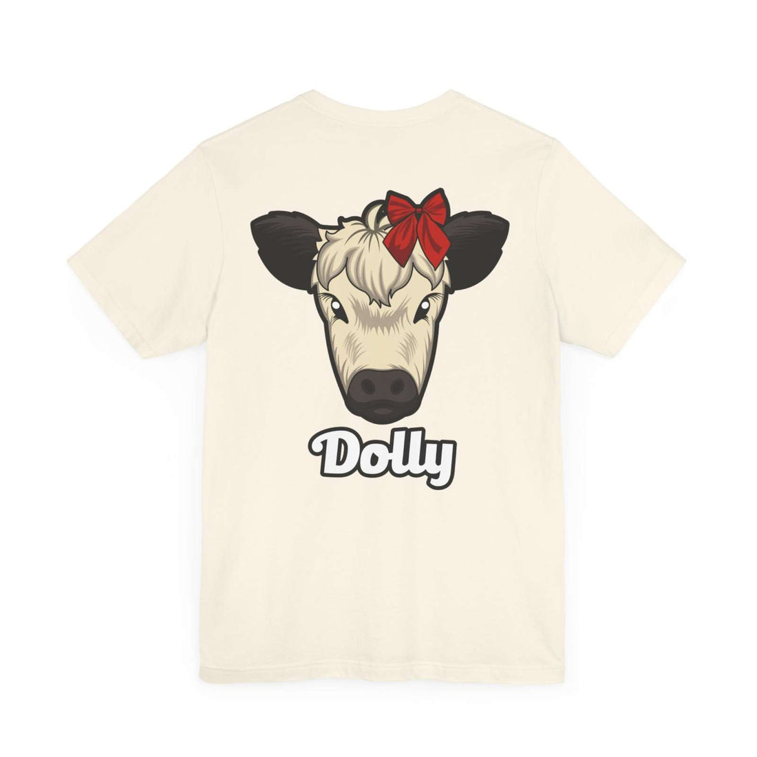 Cream Country Cow Graphic Tee featuring a cow named Dolly with a red bow on the back