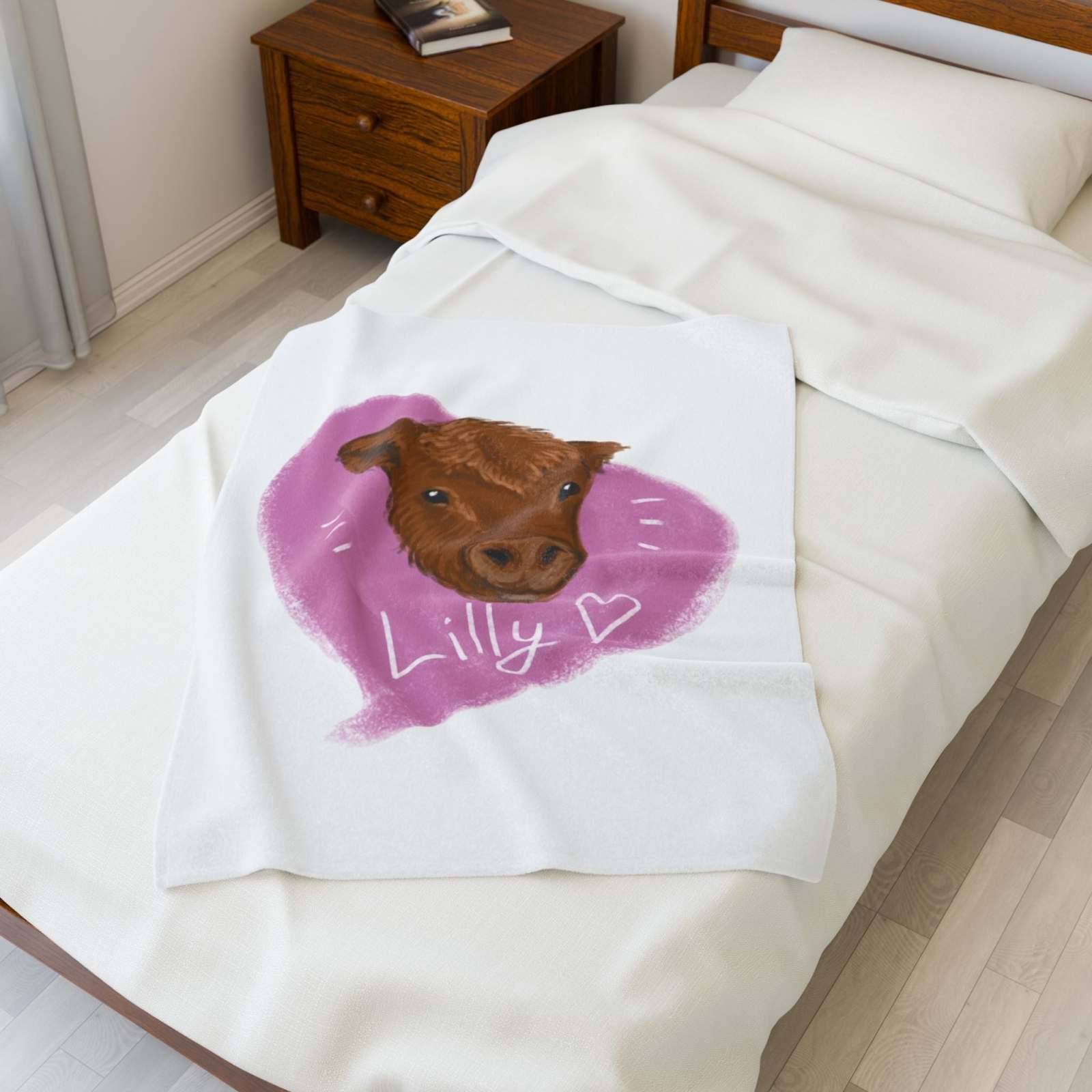 Cute Cow Plush Blanket with brown cow face and Lilly heart design on white bed in cozy farmhouse bedroom