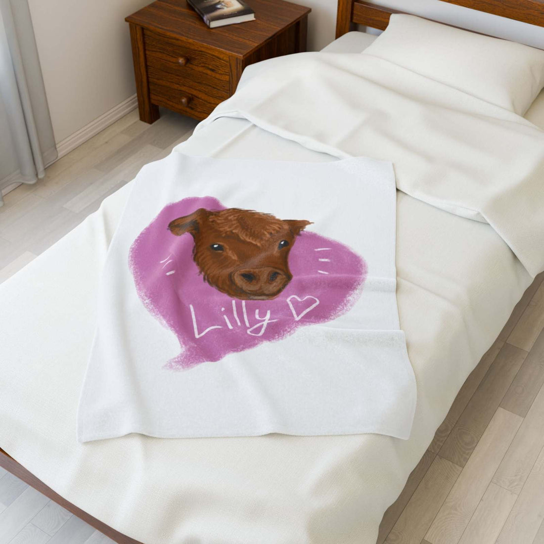 Cute Cow Plush Blanket with brown cow face and Lilly heart design on white bed in cozy farmhouse bedroom