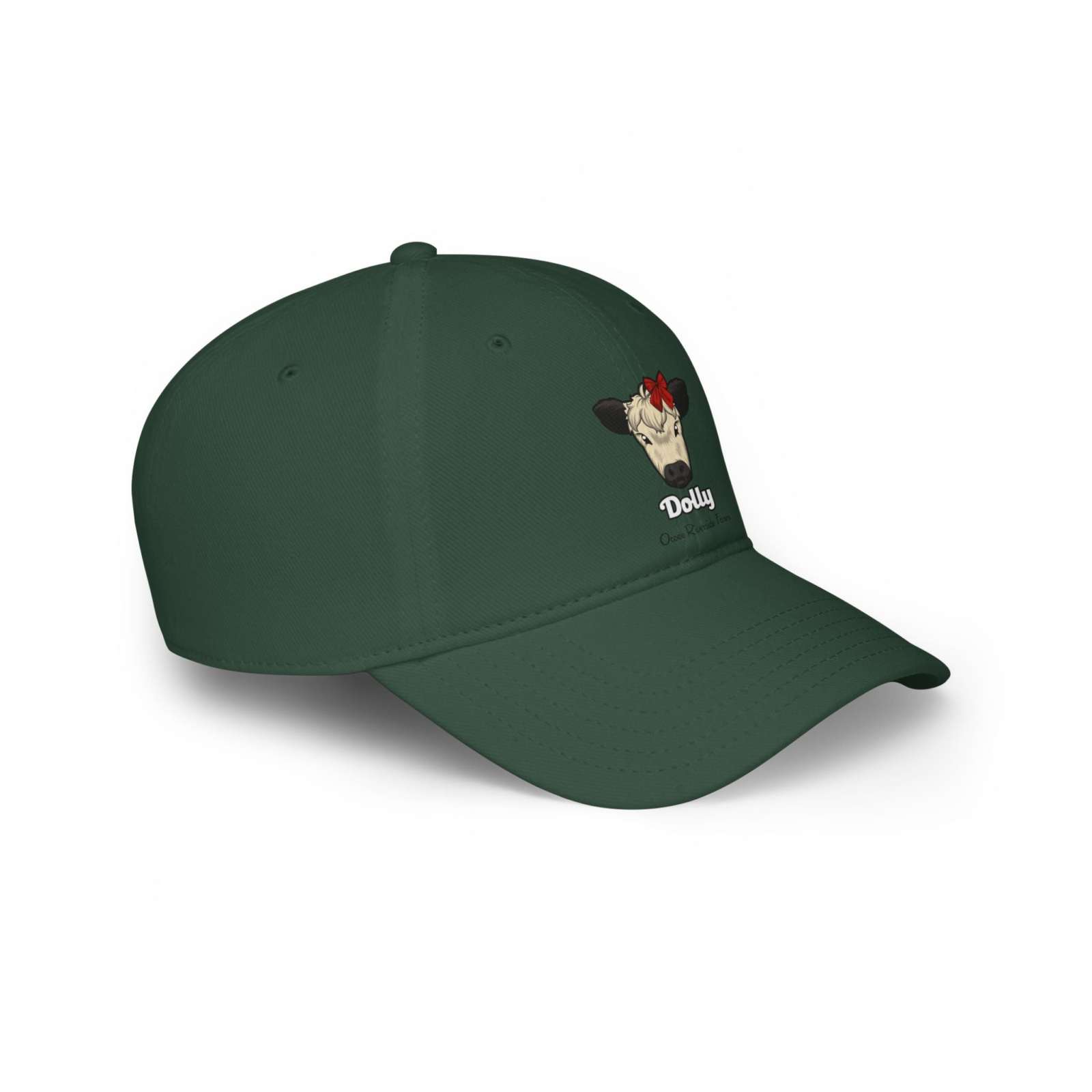 Dark green low profile baseball cap with an embroidered cow named Dolly wearing a red bow, adjustable Velcro closure, made of 100% cotton
