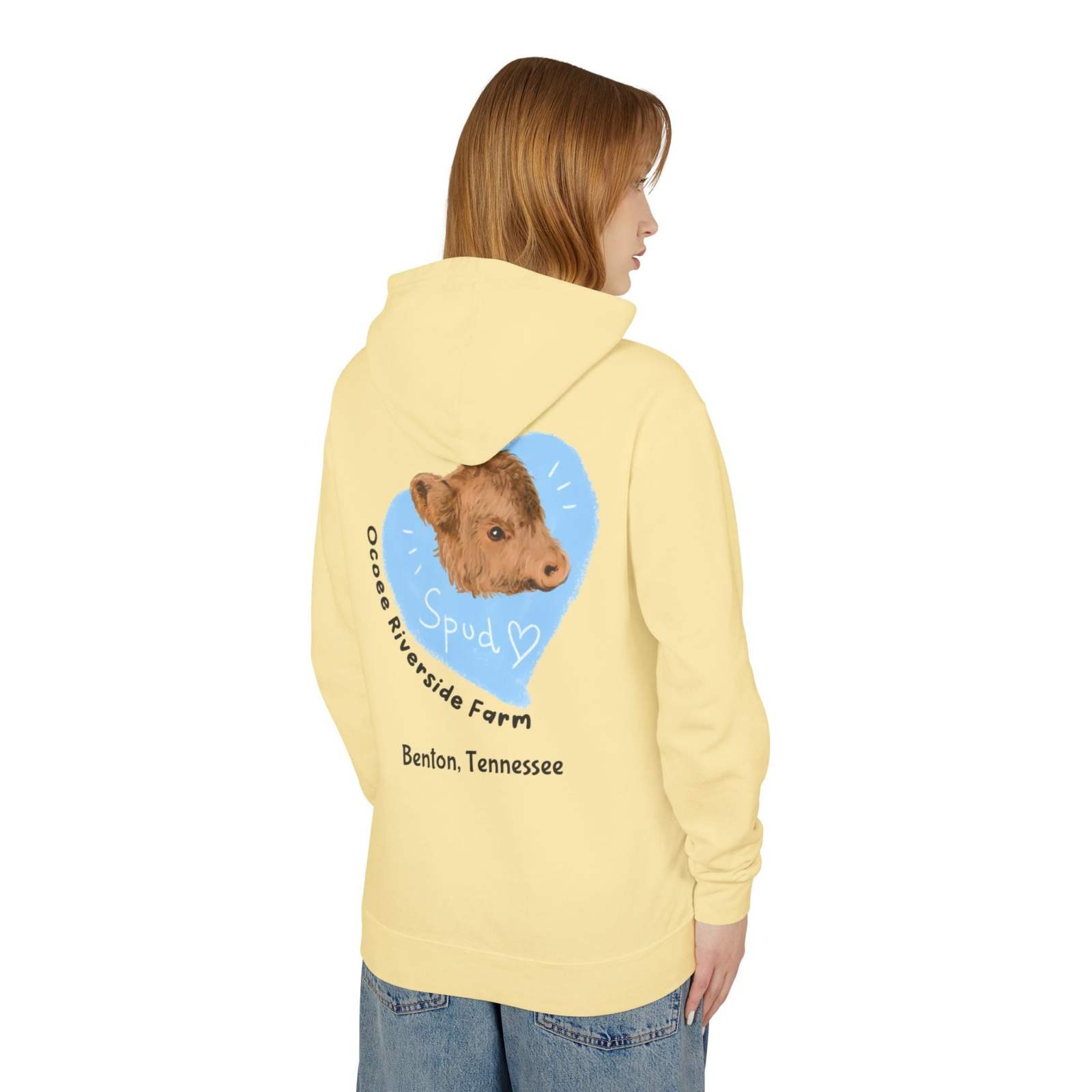 Person wearing a pale yellow Cute Cow Lightweight Hoodie with a cow graphic and "Ocoee Riverside Farm, Benton, Tennessee" text on the back.