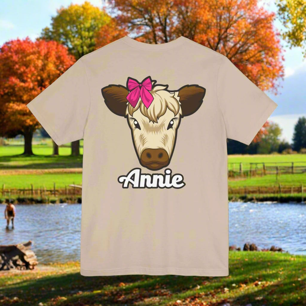 Farm Life T-Shirt featuring Annie the Cow with a red bow, ideal for country living enthusiasts.