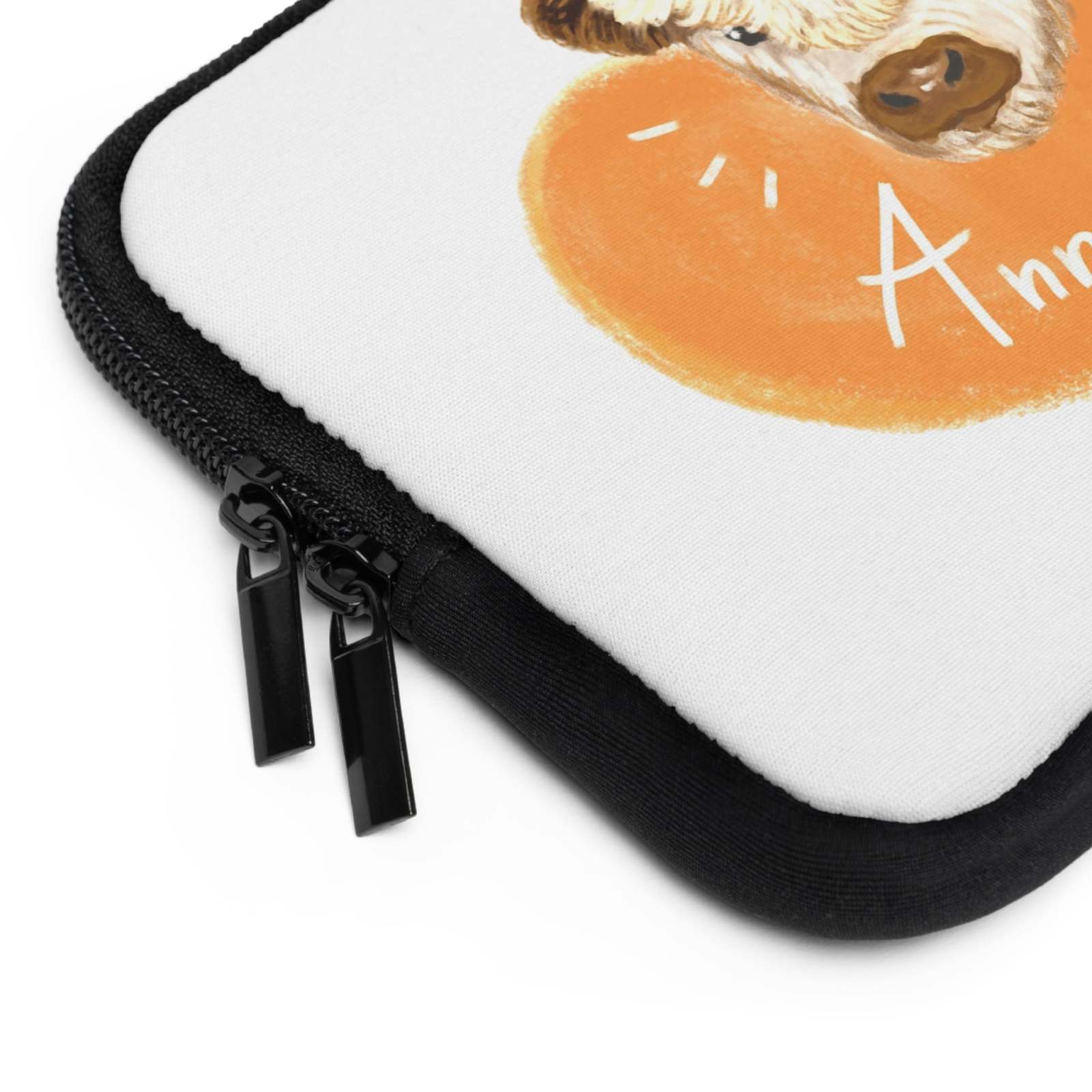 Close-up of custom cow laptop sleeve corner with dual zipper and heart design on white neoprene surface