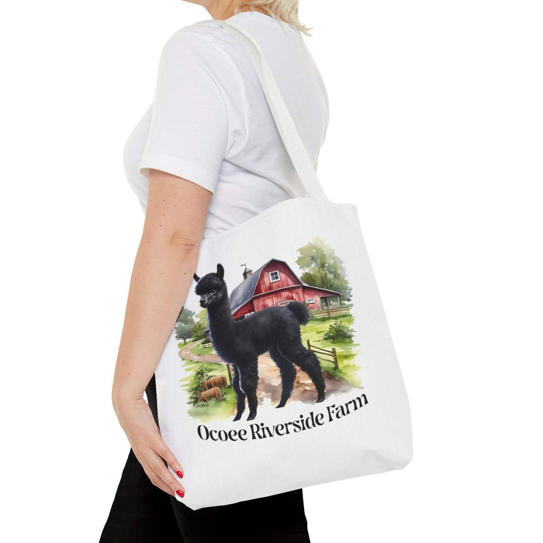 Eco-friendly white tote bag featuring a black llama and red barn design with "Ocoee Riverside Farm" text, perfect for shopping.