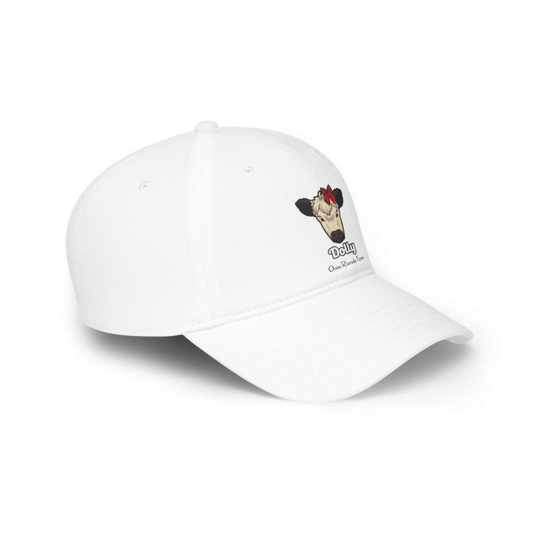 White low profile cotton baseball cap with a cow wearing a red bow named Dolly embroidered on the front and adjustable Velcro closure.