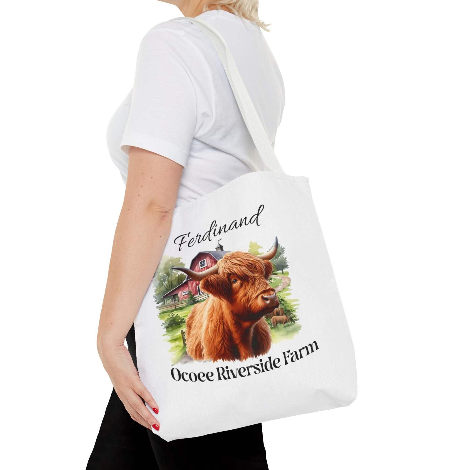 Woman carrying eco-friendly Ferdinand Scottish Highland Tote Bag with Highland cow and Ocoee Riverside Farm design
