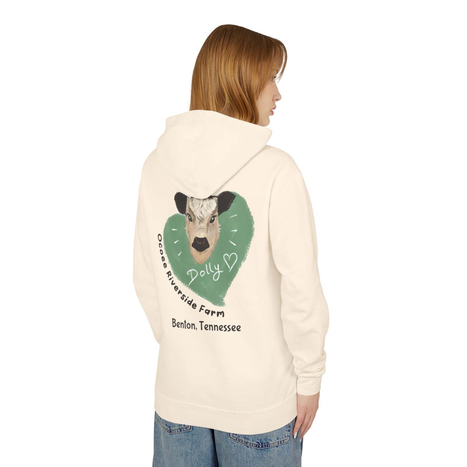 Back view of a person wearing a cream Cozy Cow Hoodie with a cow illustration and Ocoee Riverside Farm text on the back