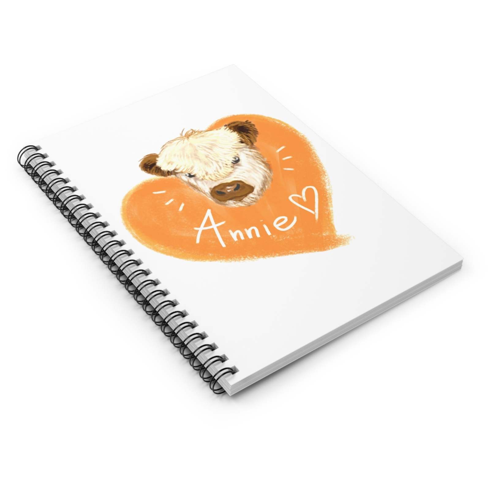 Cute Cow Spiral Notebook with whimsical cow illustration named Annie and orange heart design on white cover, spiral binding, compact size.