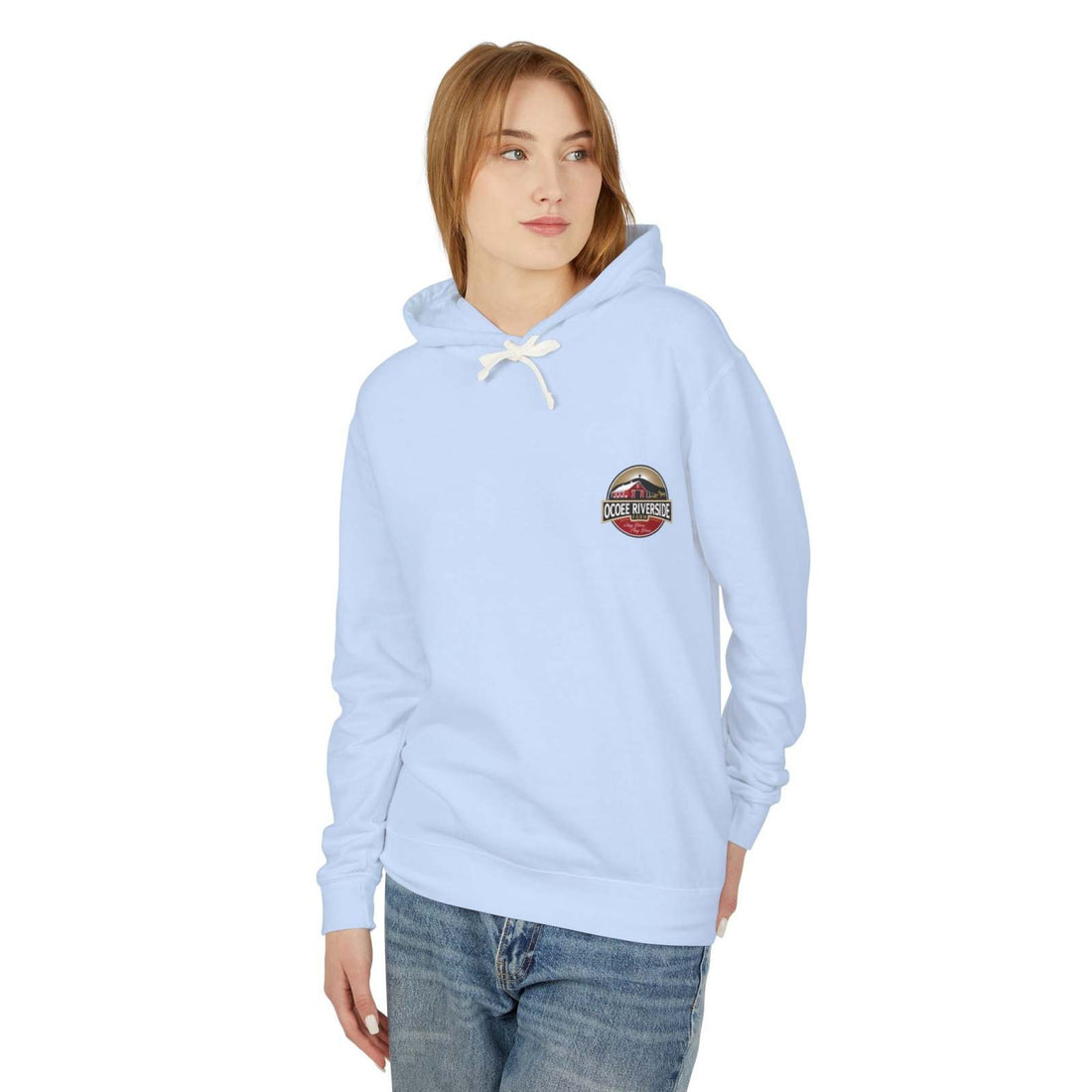 Woman wearing light blue Cozy Cow Hoodie with Ocoee Riverside Farm logo, relaxed fit and hood with drawstrings