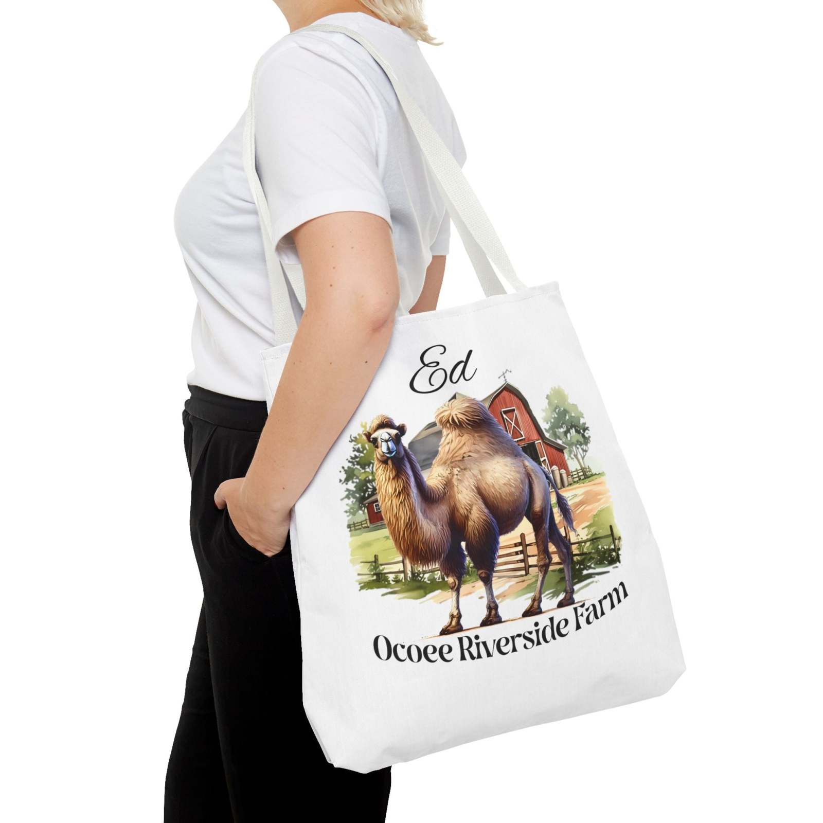 Woman carrying Ed Camel Tote Bag featuring Ocoee Riverside Farm design, eco-friendly shopping tote with camel illustration