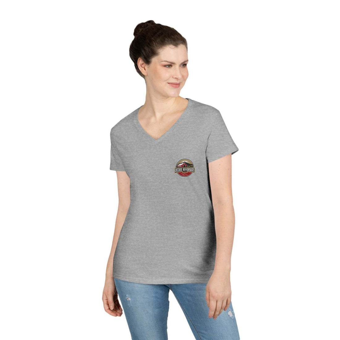 Woman wearing a gray Rustic Farm Style V-Neck t-shirt with a small farm-themed logo on the left chest, paired with blue jeans.