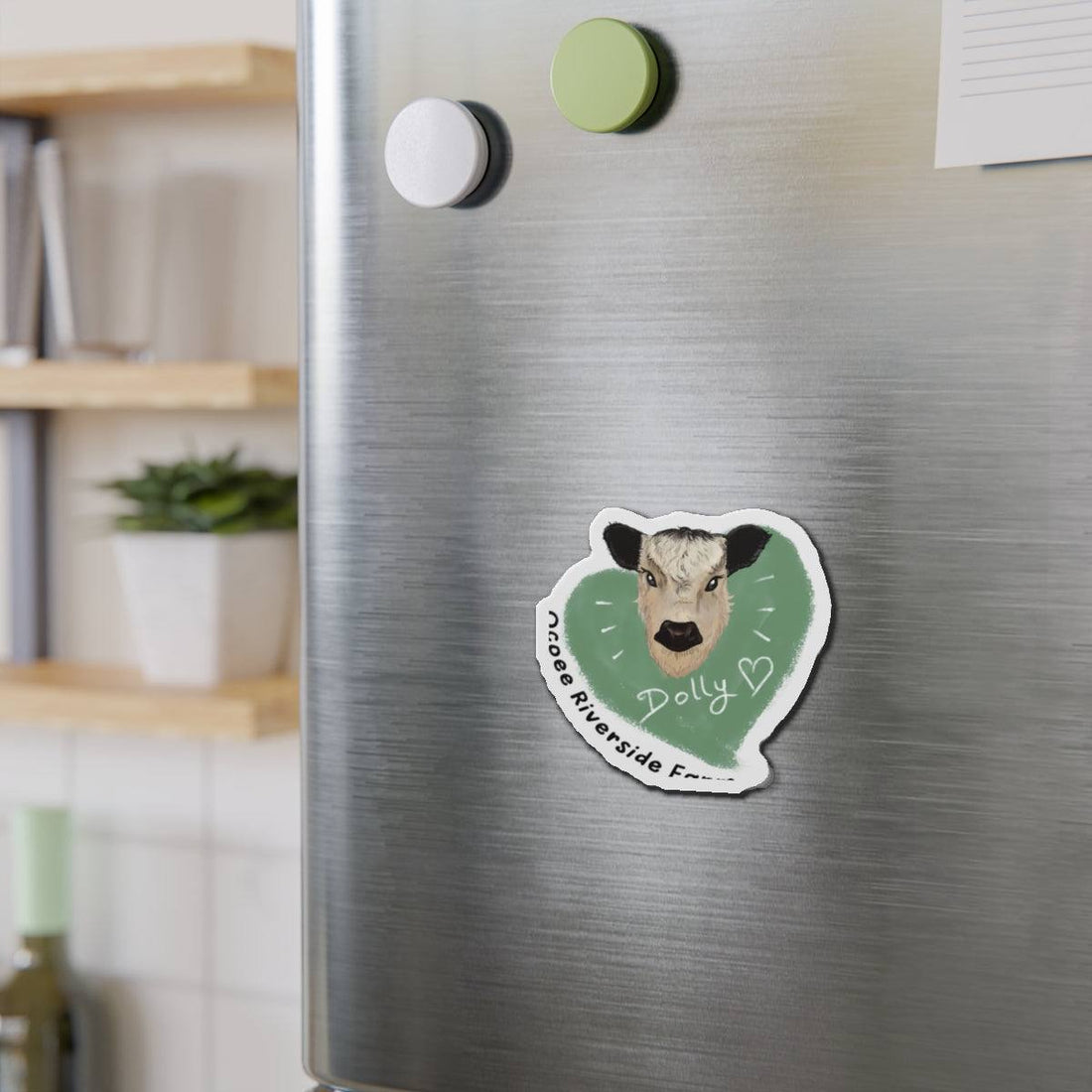 Cute cow die-cut magnet with a farm animal design on a refrigerator door