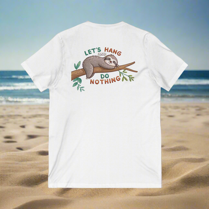 White unisex V-neck t-shirt with a cute sloth hanging on a branch and text "Let's Hang and Do Nothing" printed on the back, shown on a beach background.