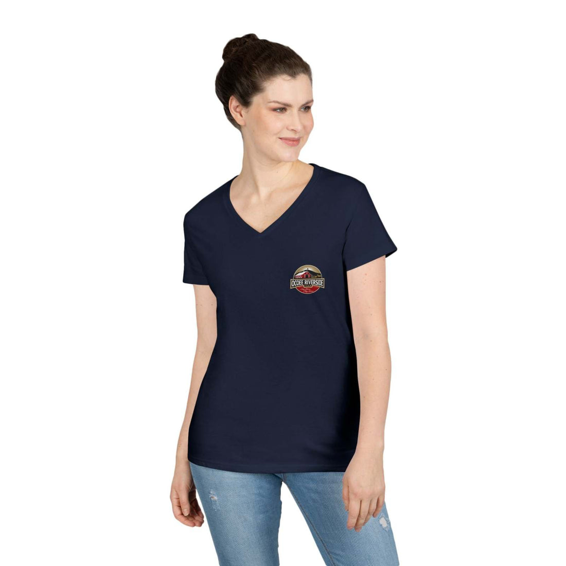 Woman wearing navy Spud Heart Women’s V-Neck T-Shirt with farm-themed logo on chest and light blue jeans