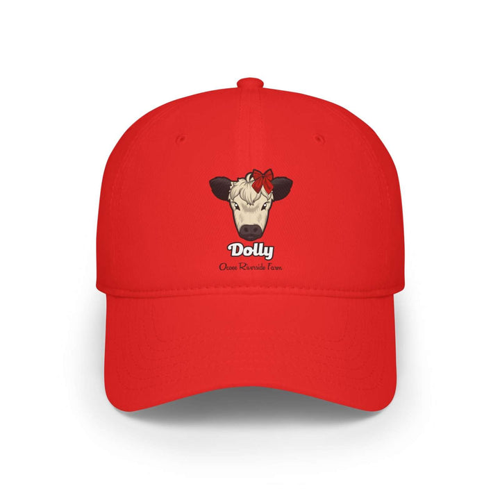 Red cow baseball cap featuring a cow named Dolly with a red bow on its head embroidered on the front