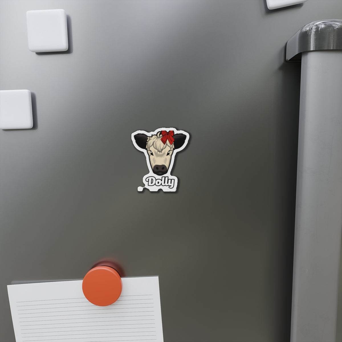 Charming cow die-cut magnet with red bow and name Dolly on grey refrigerator door