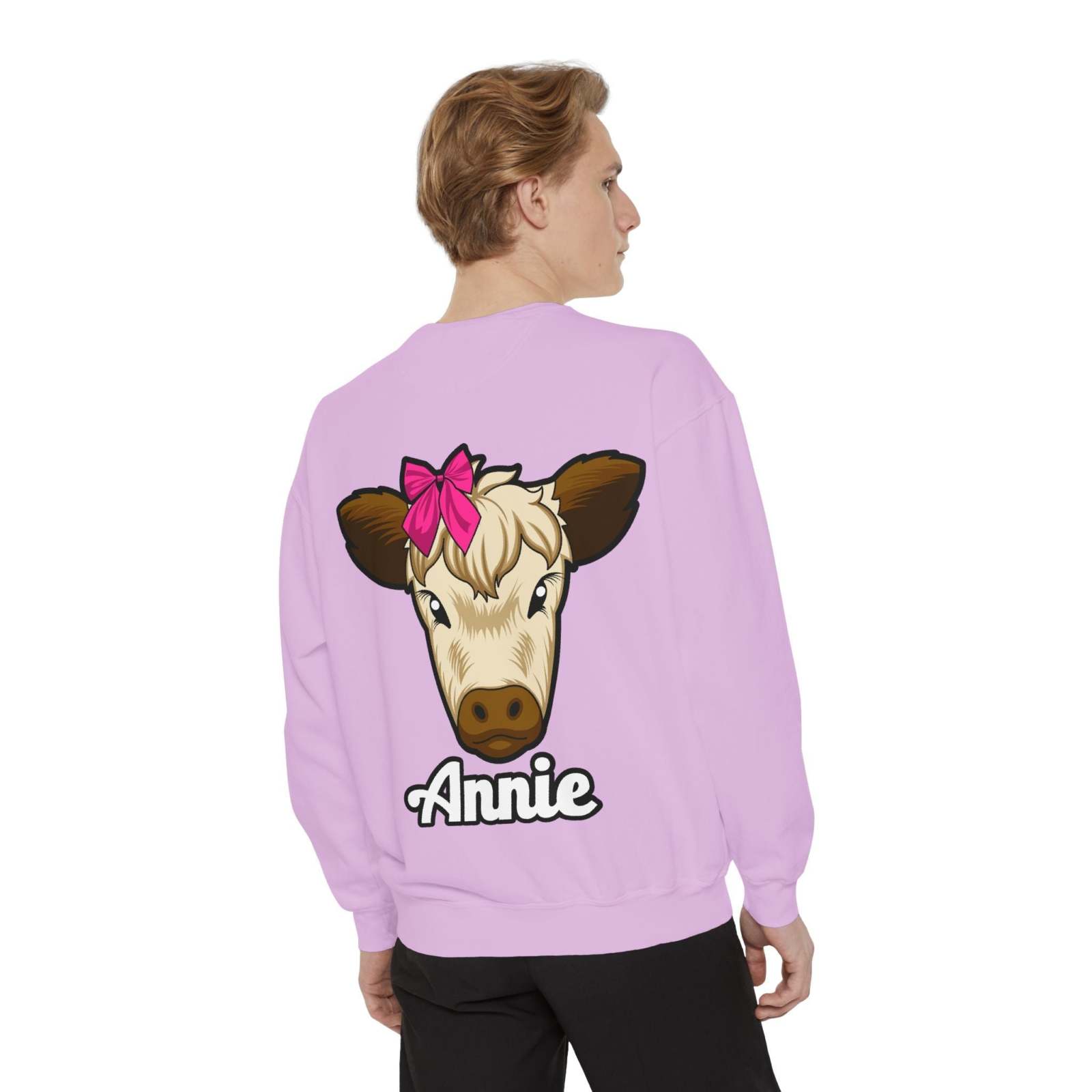 Cute farm animal sweatshirt with a cow featuring a red bow on a lavender background.