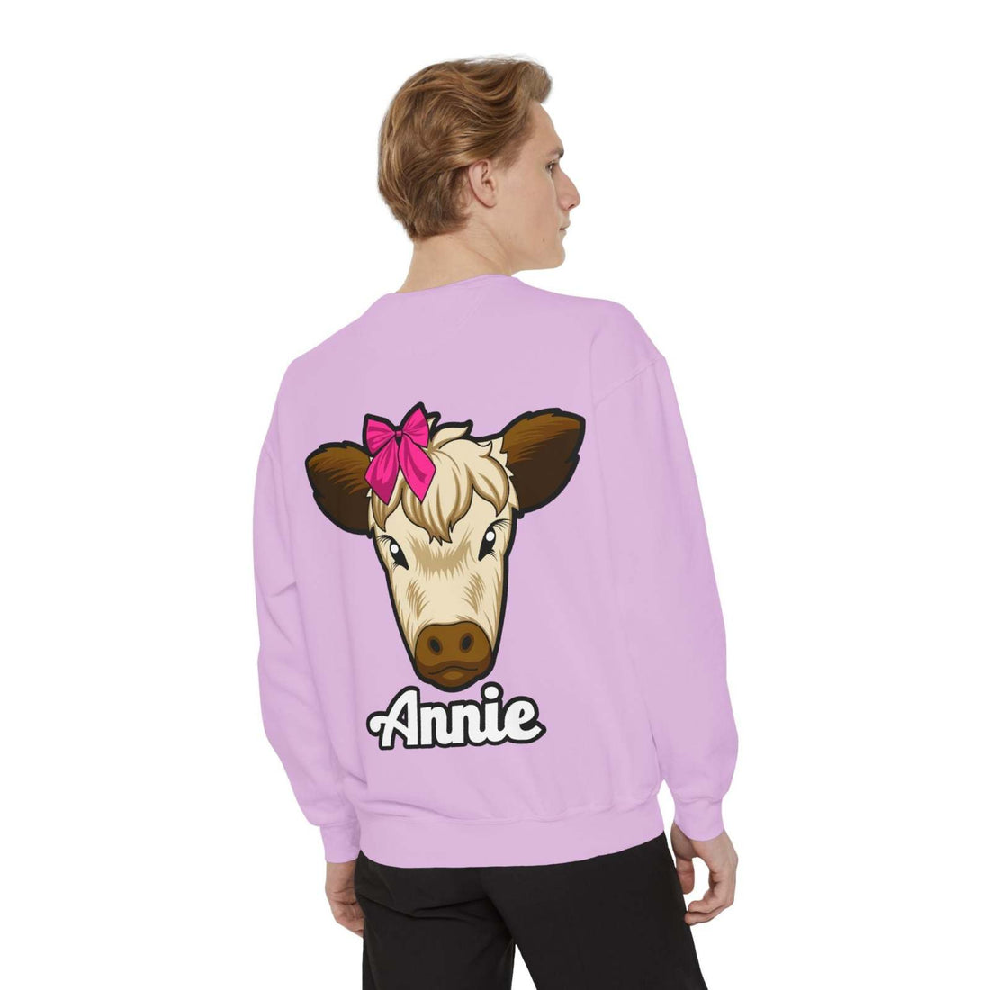Cute farm animal sweatshirt with a cow featuring a red bow on a lavender background.