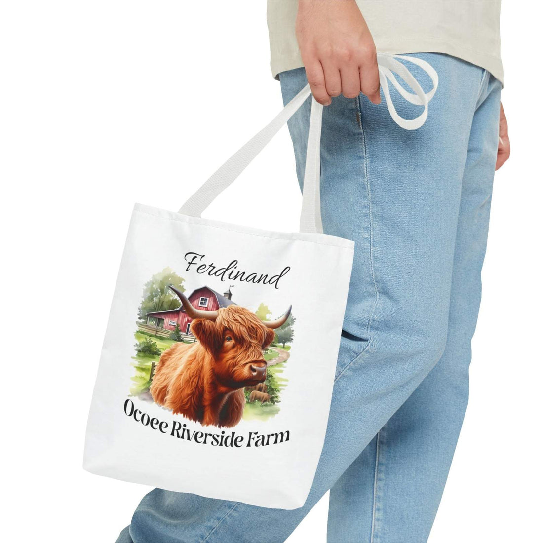 Ferdinand Scottish Highland Tote Bag with farm animal design held by person wearing jeans, eco-friendly shopping bag from Ocoee Riverside Farm