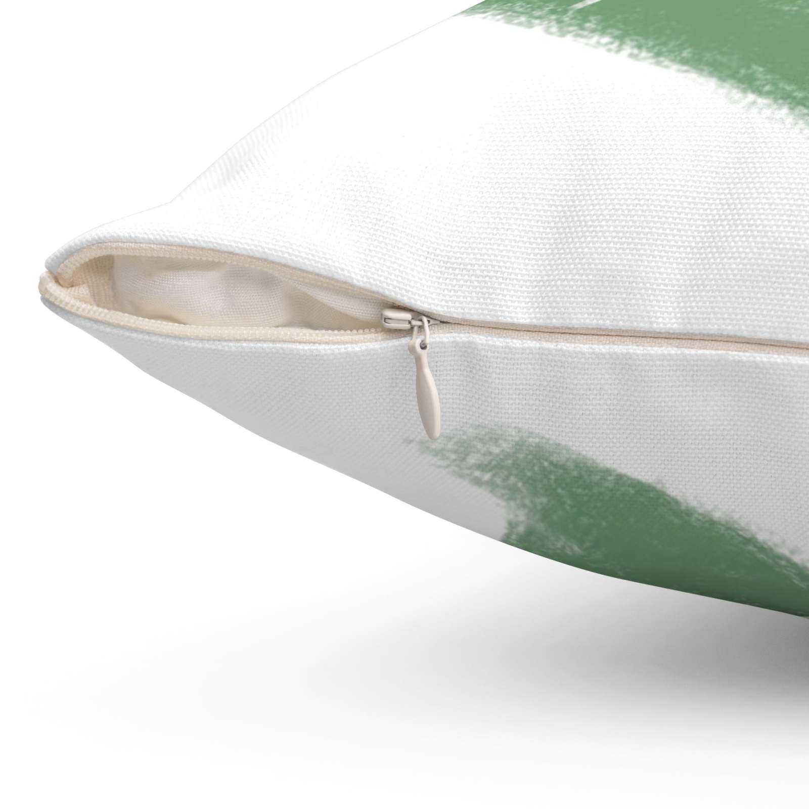 Close-up of spun polyester heart pillow with beige zipper and green-white design detail
