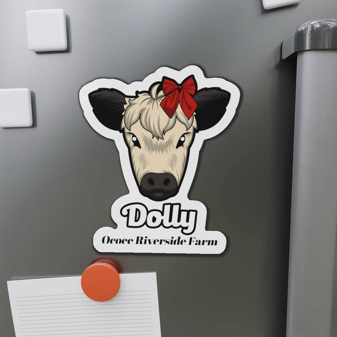 Charming Cow Die-Cut Magnet with a cute cow face and red bow on a gray refrigerator door, farmhouse decor accessory