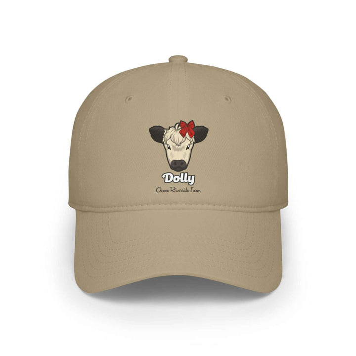 Beige cow baseball cap featuring Dolly the cow with a red bow and Ocoee Riverside Farm text