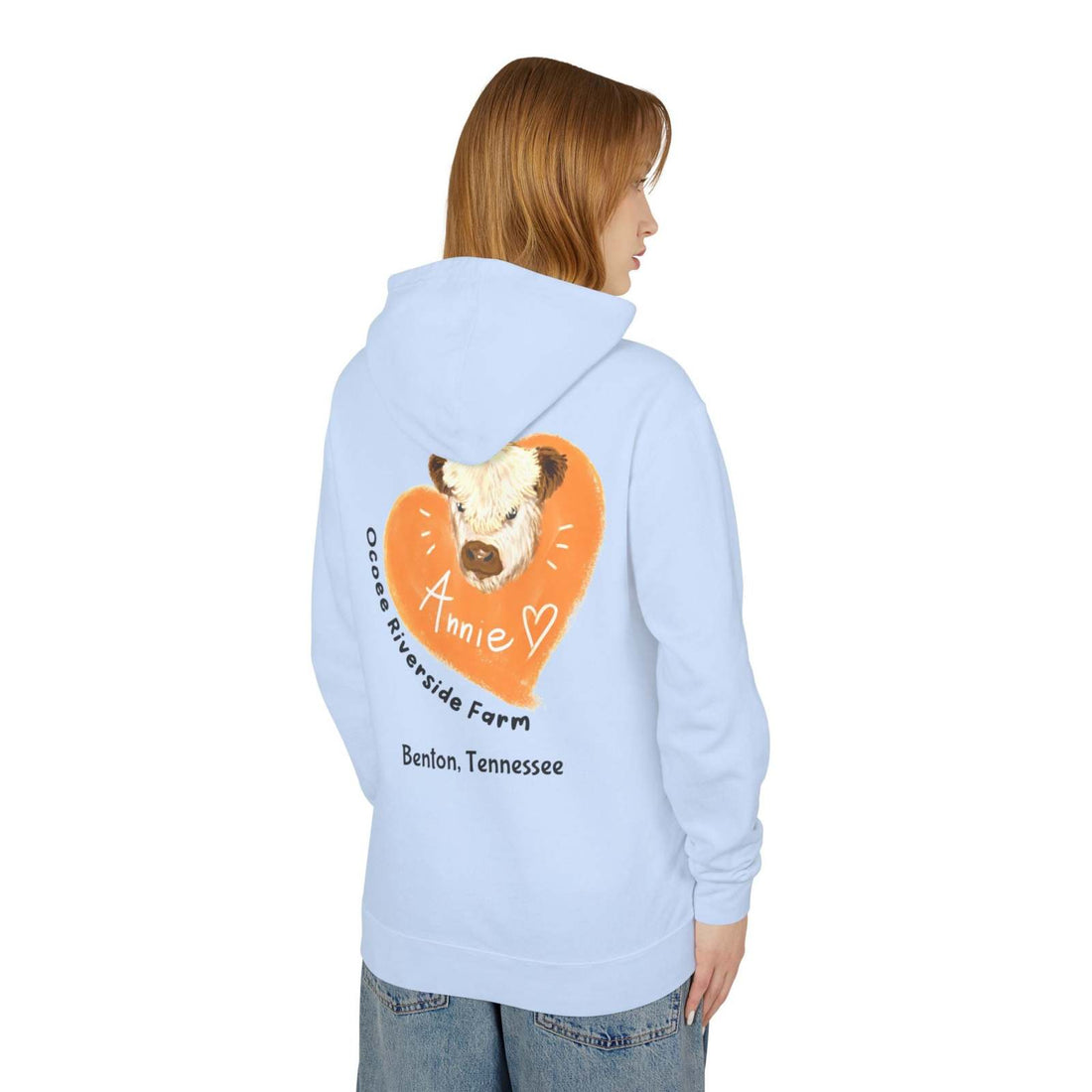Light blue unisex hooded sweatshirt featuring adorable cow design with "Annie" and Ocoee Riverside Farm text on the back