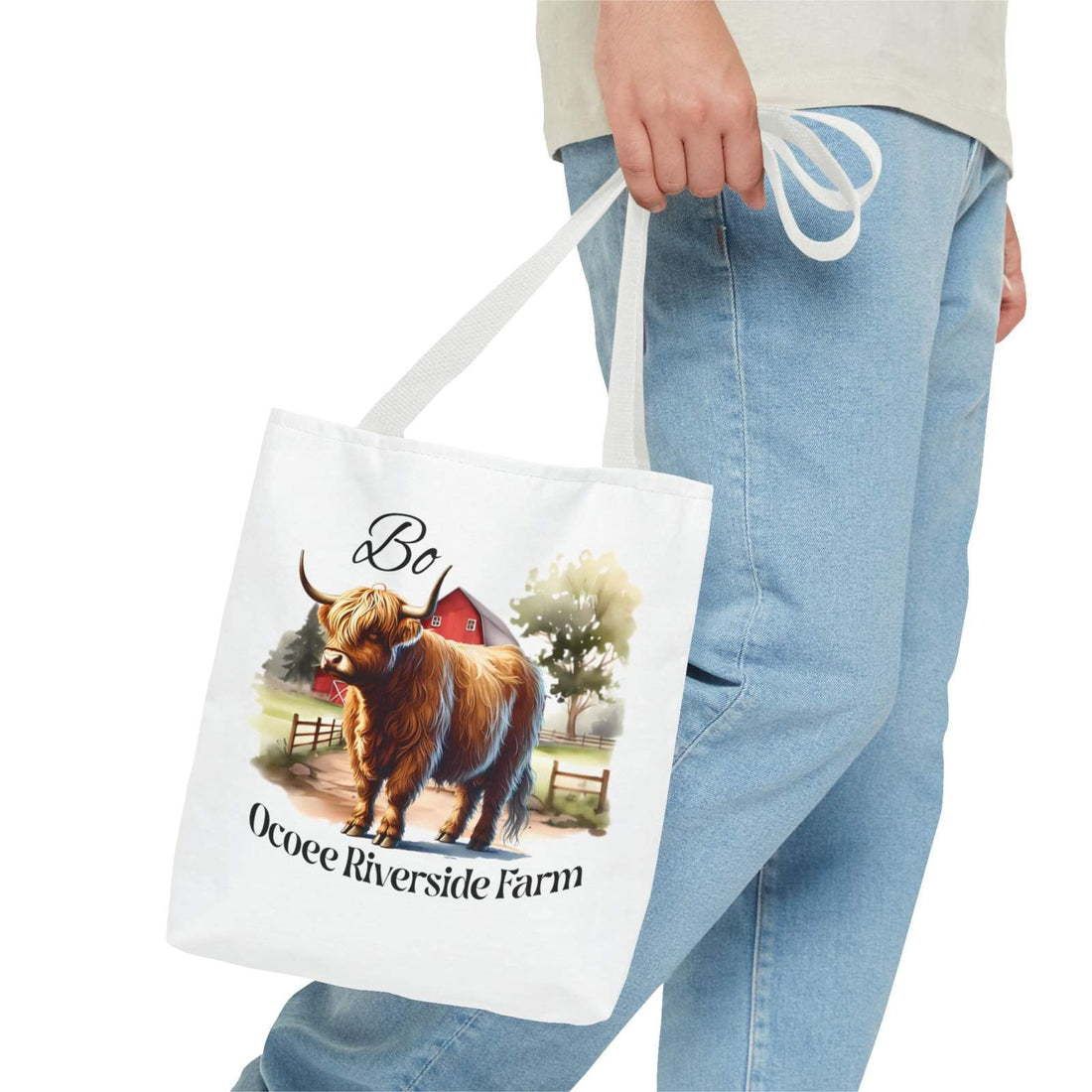 Bo Scottish Highland Tote Bag with Ocoee Riverside Farm design, eco-friendly shopping bag held by person wearing jeans