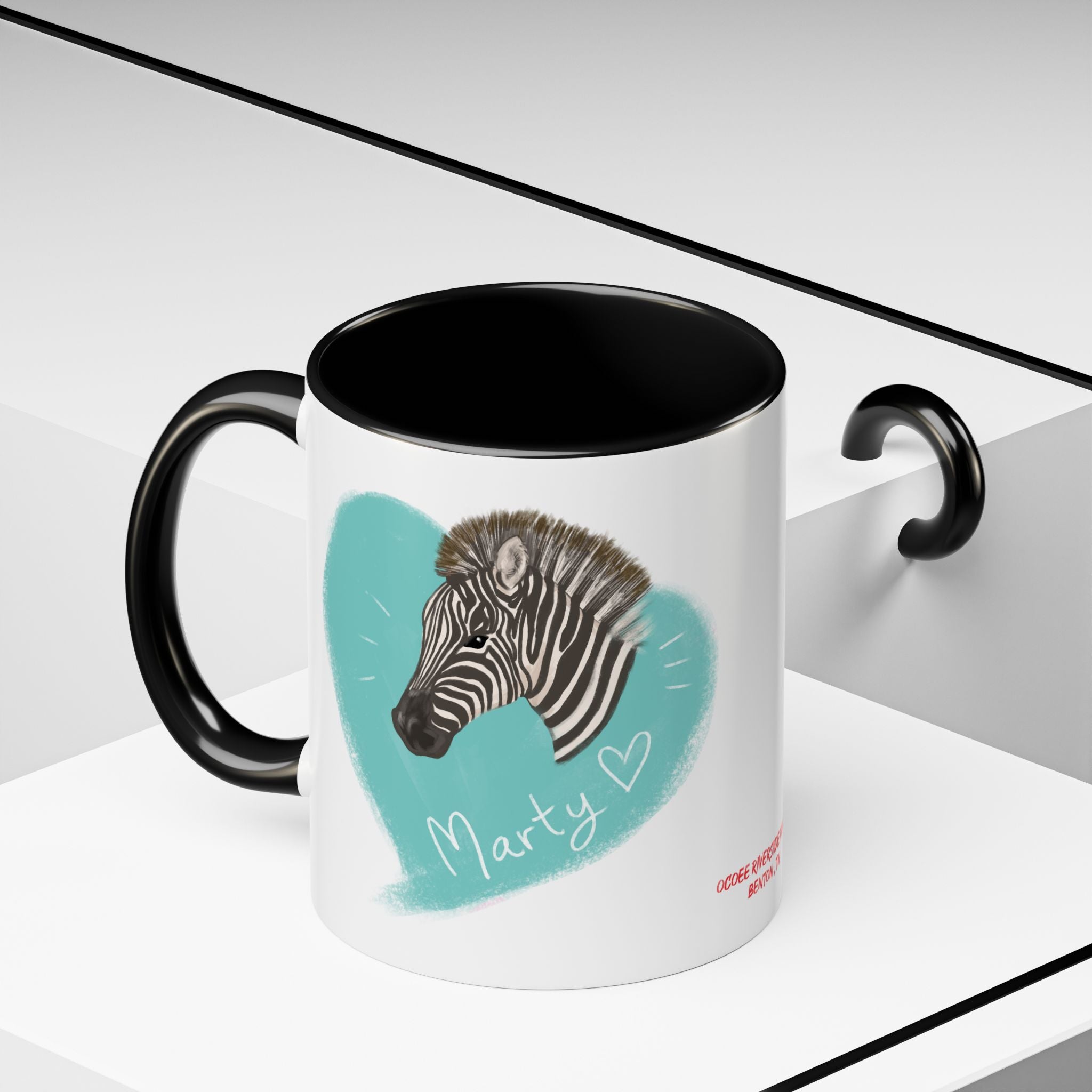 A zebra adorned with the word "Marty" creatively integrated into its stripes at Ocoee Riverside Farm Coffee Mug