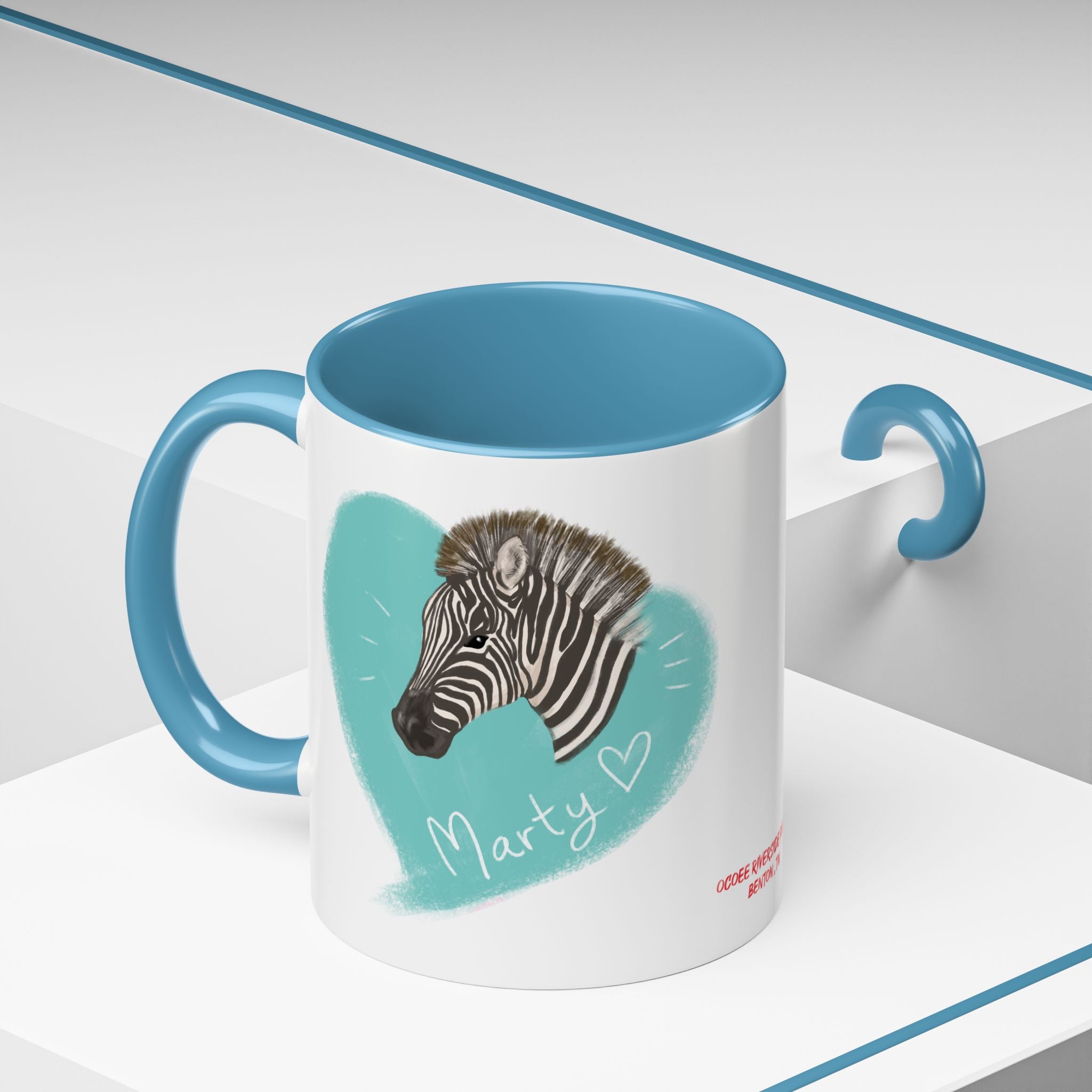 A zebra adorned with the word "Marty" creatively integrated into its stripes at Ocoee Riverside Farm Coffee Mug